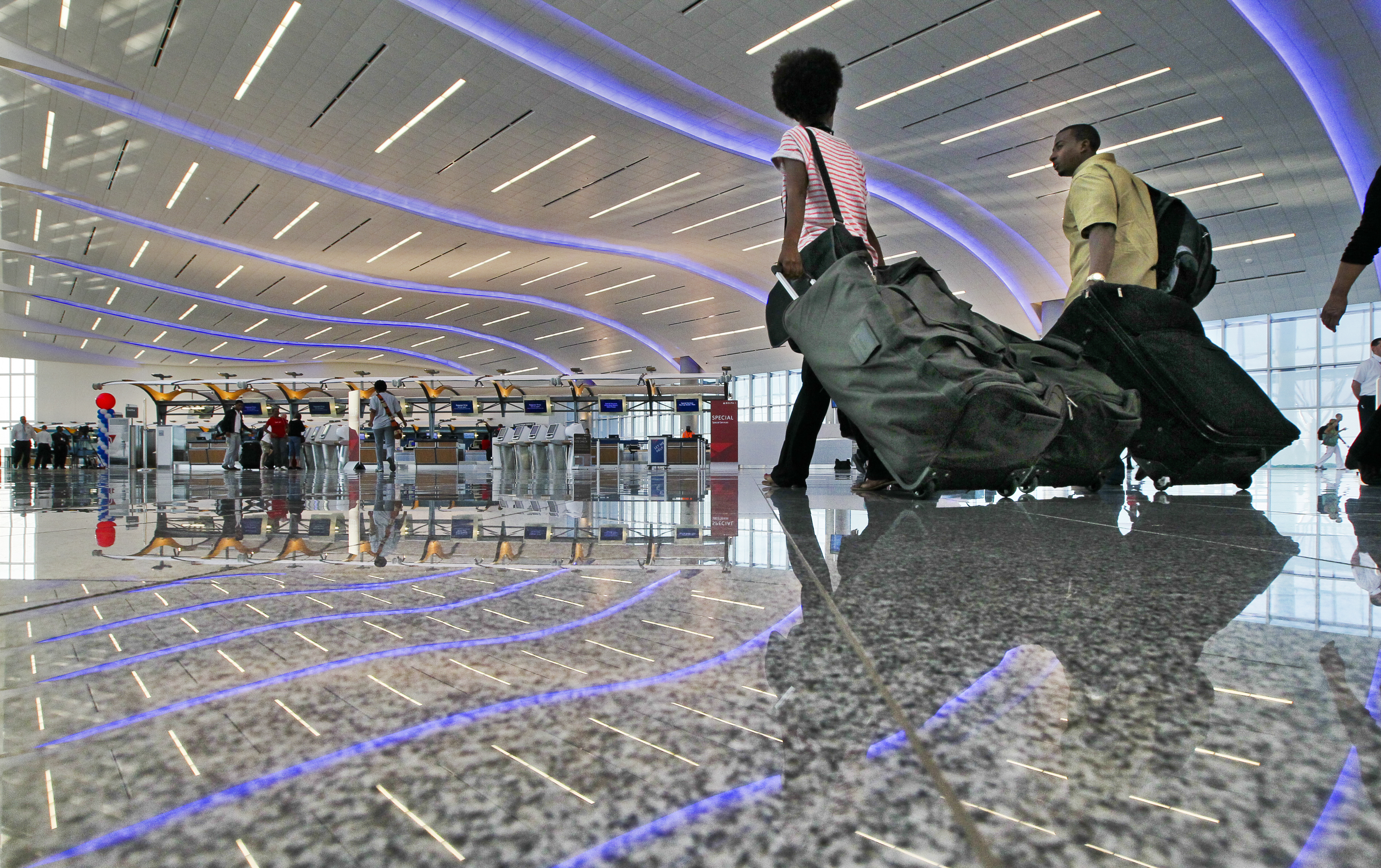 May 16, 2012 Atlanta: People arrived early in the morning to check in Wednesday, May 16,2012 before the first flight took off from the new international terminal at Hartsfield-Jackson International Airport at 1:25 p.m. The new terminal's price tag exceeded $1.4 billion. Airport work is funded through a combination of passenger facility charges, airline lease and landing fee payments, revenue from airport operations like concessions and parking, and federal grants. The revenue streams are often used to back bonds or other financing. critics of the new terminal complain that it cost twice original projections and has fewer gates than the original plan. They also have complained about the political process behind the scenes. Travelers in Atlanta will have to get used to accessing the new terminal by arriving on the I-75 side of what was a familiar trip to the airport by way of I-85. JOHN SPINK /