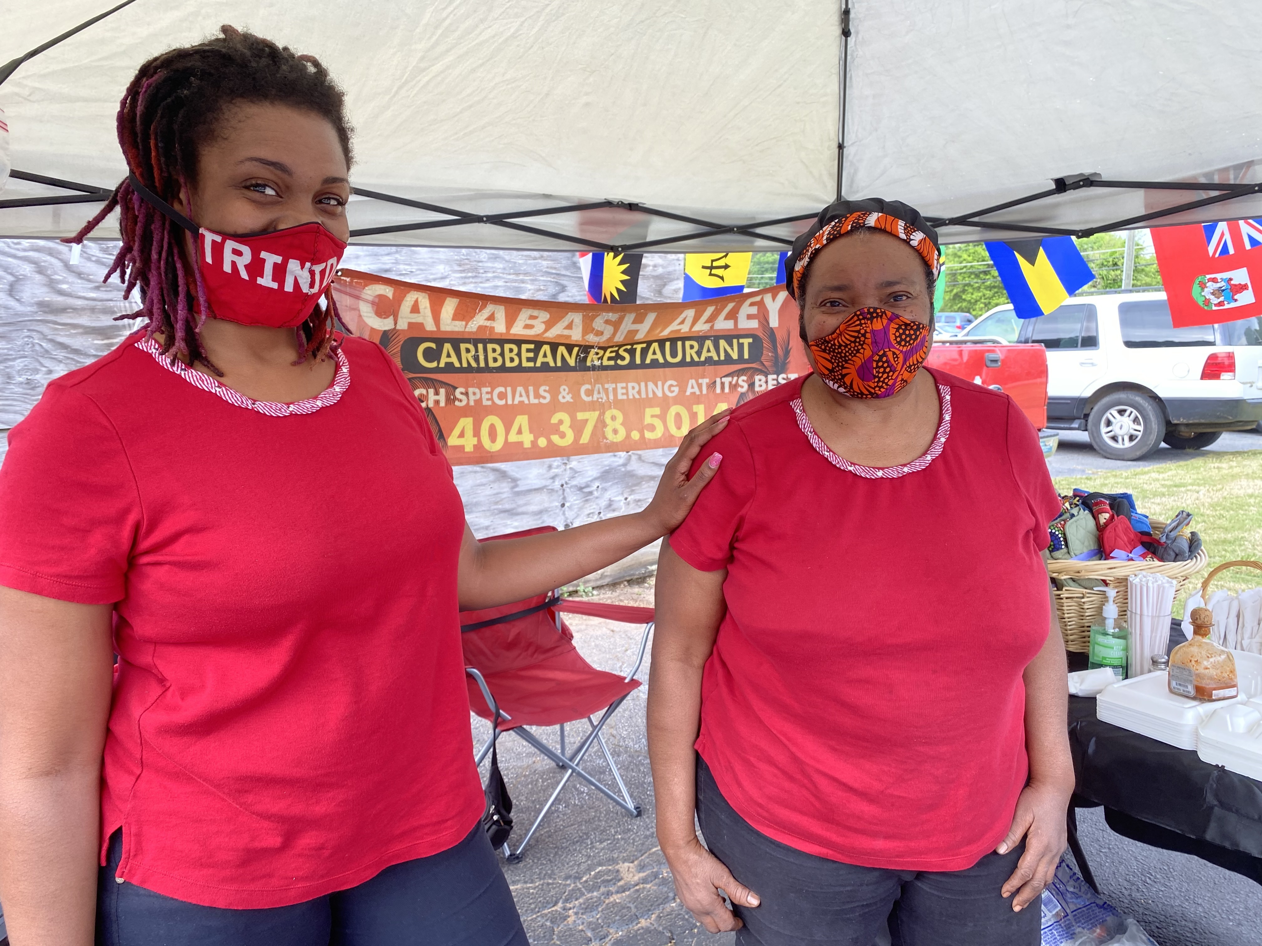 Charmaine Martin (right) and her daughter, Akilah Millar, plate up the same Caribbean fare at the Candler Black Market that they offer at their Calabash Alley restaurant in Candler Plaza. Ligaya Figueras/ligaya.figueras@ajc.com