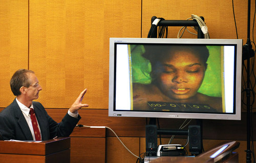 Dr. Michael Henniger of the Fulton County Medical Examiners office identifies the picture on the monitor as Sparkle Rai during the 2008 murder trial of Chiman Rai.