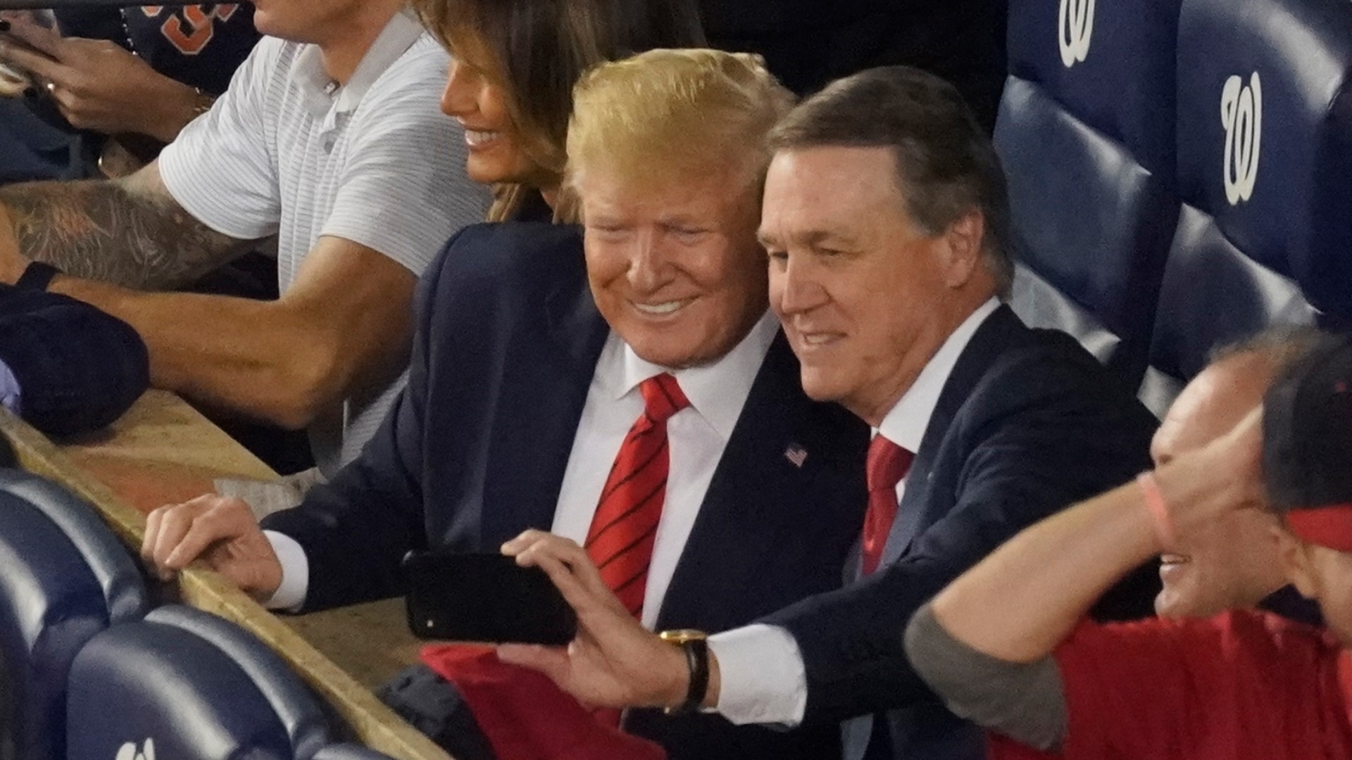 Sen. David Perdue, R-Ga., takes a selfie with President Donald Trump during the seventh inning of Game 5 of the baseball World Series between the Houston Astros and the Washington Nationals Sunday, Oct. 27, 2019, in Washington. (AP Photo/Pablo Martinez Monsivais)