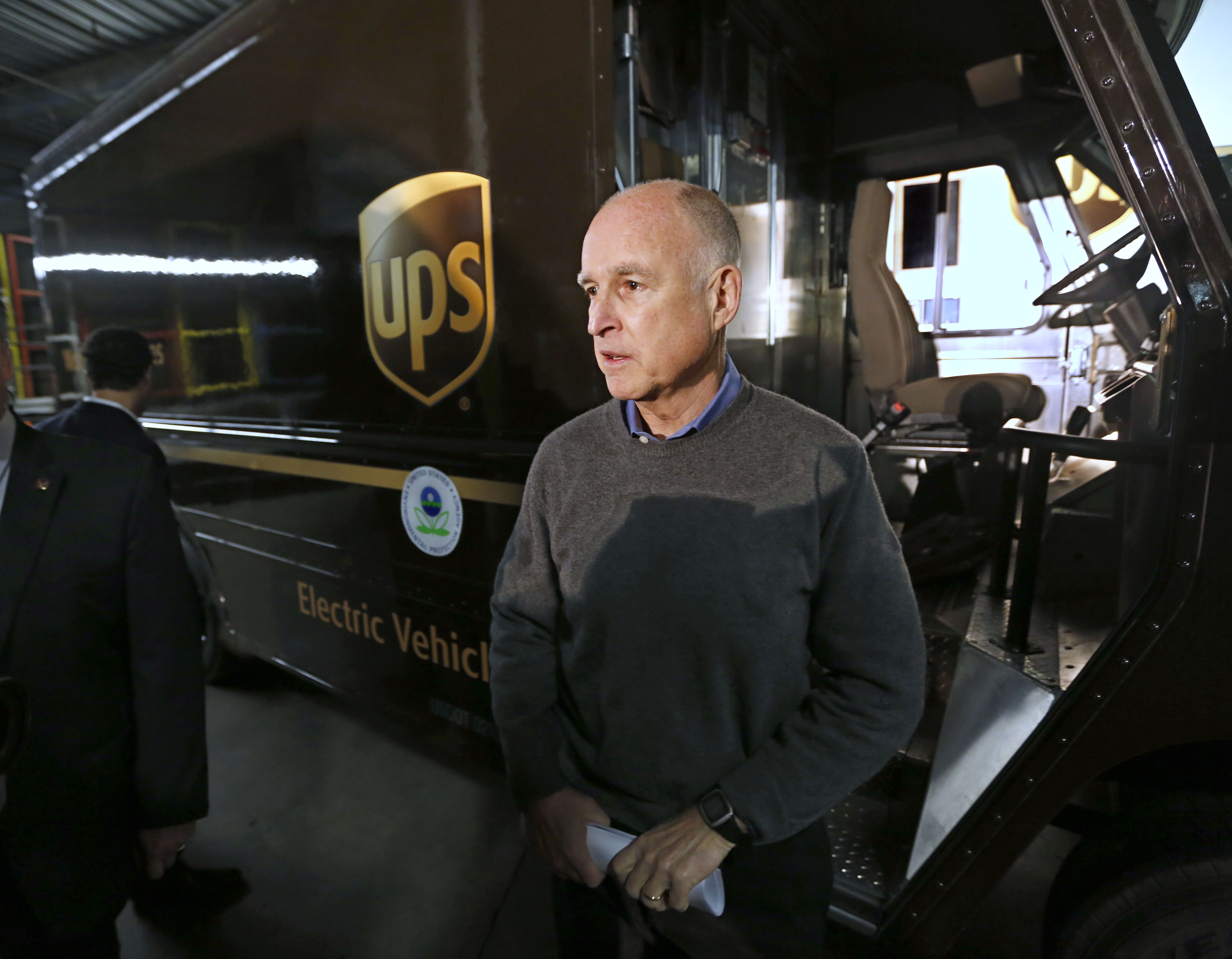 FILE PHOTO: California Gov. Jerry Brown talks to reporters after inspecting an electric-powered UPS delivery truck at the UPS distribution center in West Sacramento, Calif., Tuesday, Feb. 5, 2013. Brown appeared at the facility to mark the deployment of 100 of the company's zero-emission, electric delivery vehicle fleet.
