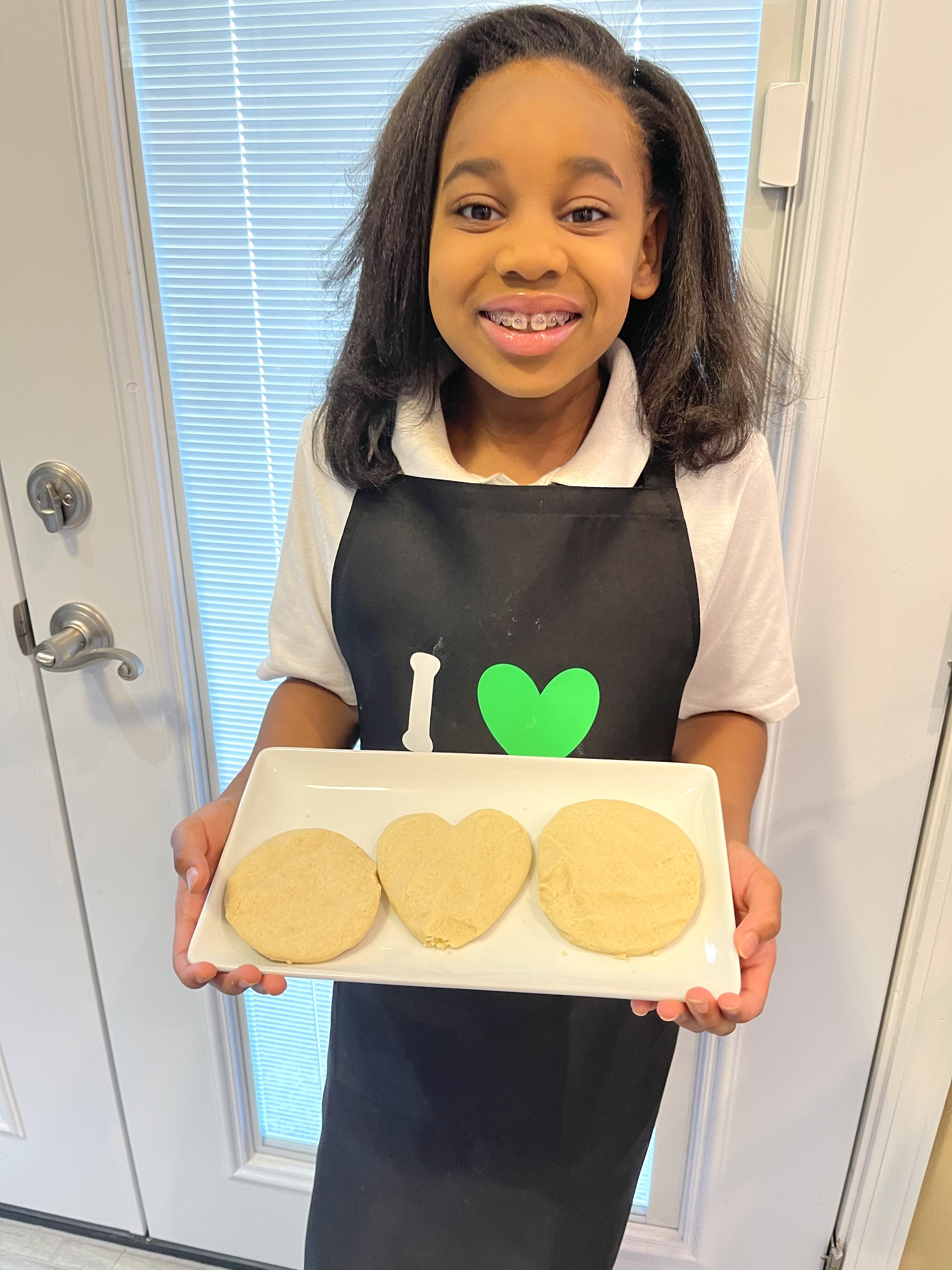 Lundyn Samuel proudly displays three of her finished Girl Scout Cookies. Courtesy of Michele Samuel