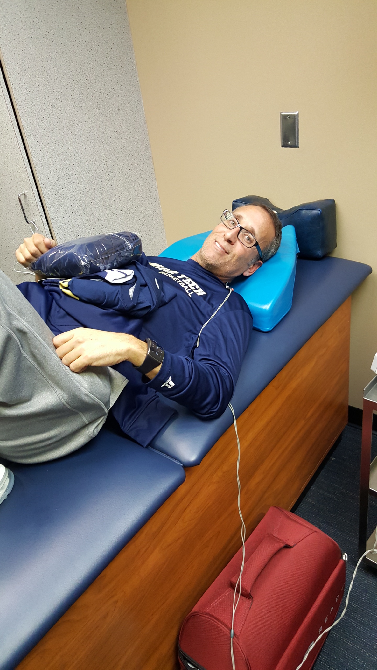 Ron Bell, who has accused Georgia Tech coach Josh Pastner of NCAA rules violations and other offenses, lies on a treatment table at Tech’s basketball training facility.