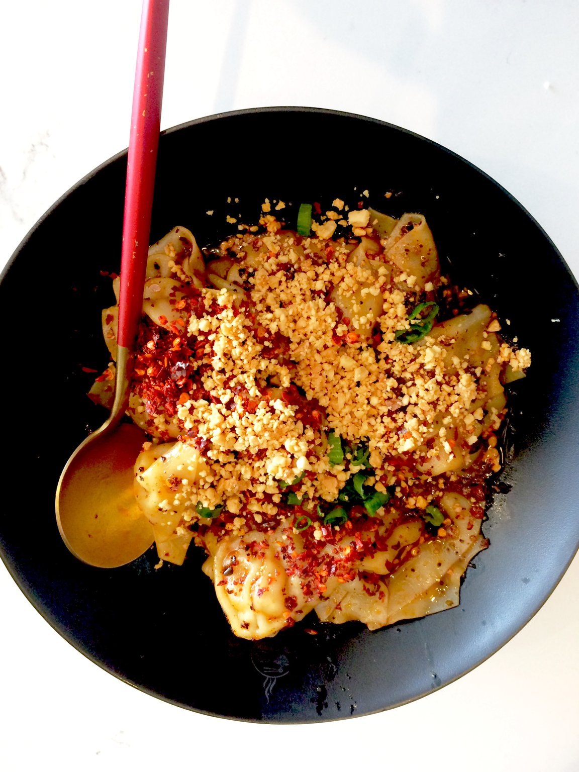 The dry wontons, filled with pork or chicken and topped with crushed peanuts, chile peppers and green onions, are a standout at Gu’s Kitchen. CONTRIBUTED BY WENDELL BROCK