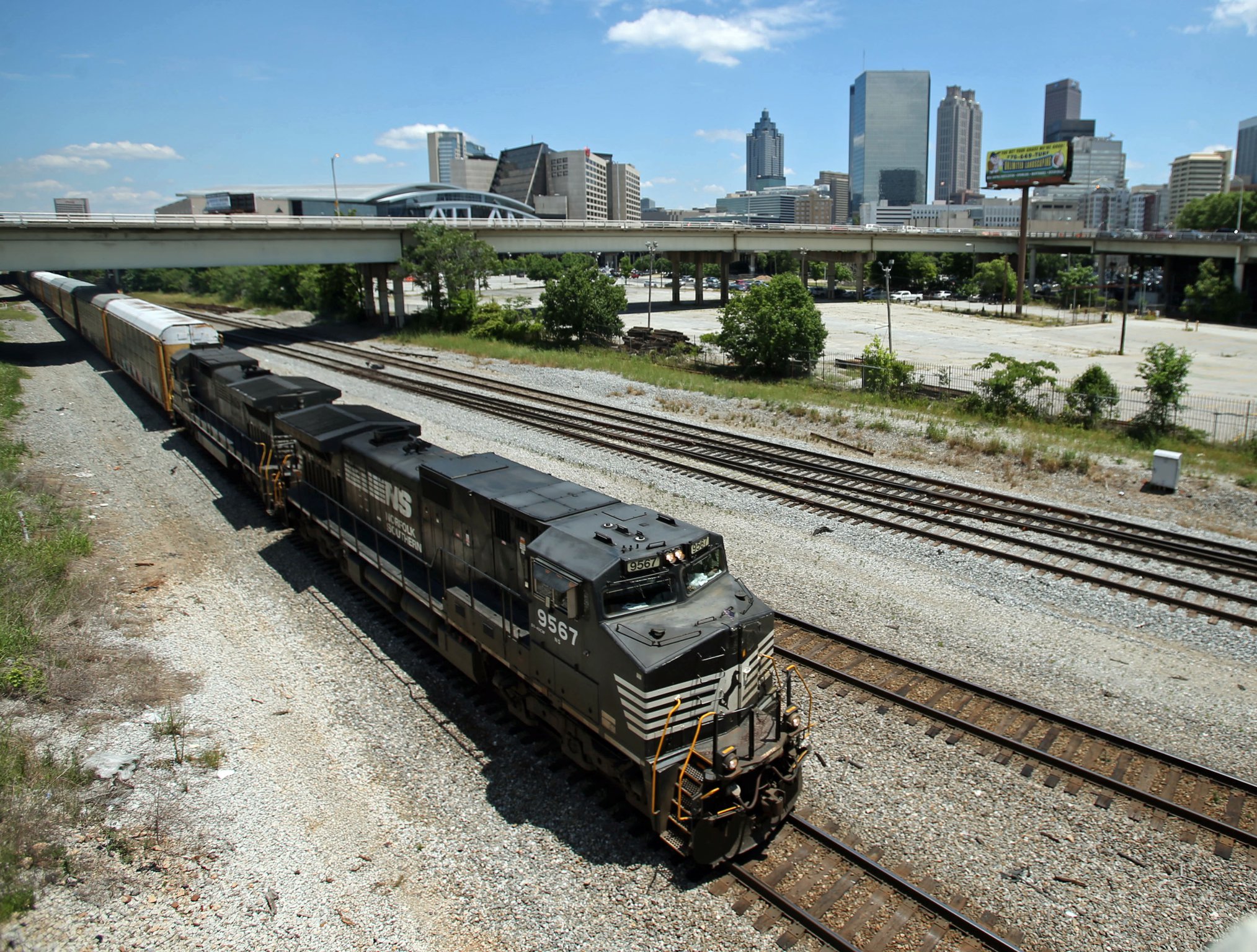 A Norfolk-Southern train travels near the Mitchell Street bridge in the downtown Atlanta’s Gulch. JASON GETZ / JGETZ@AJC.COM
