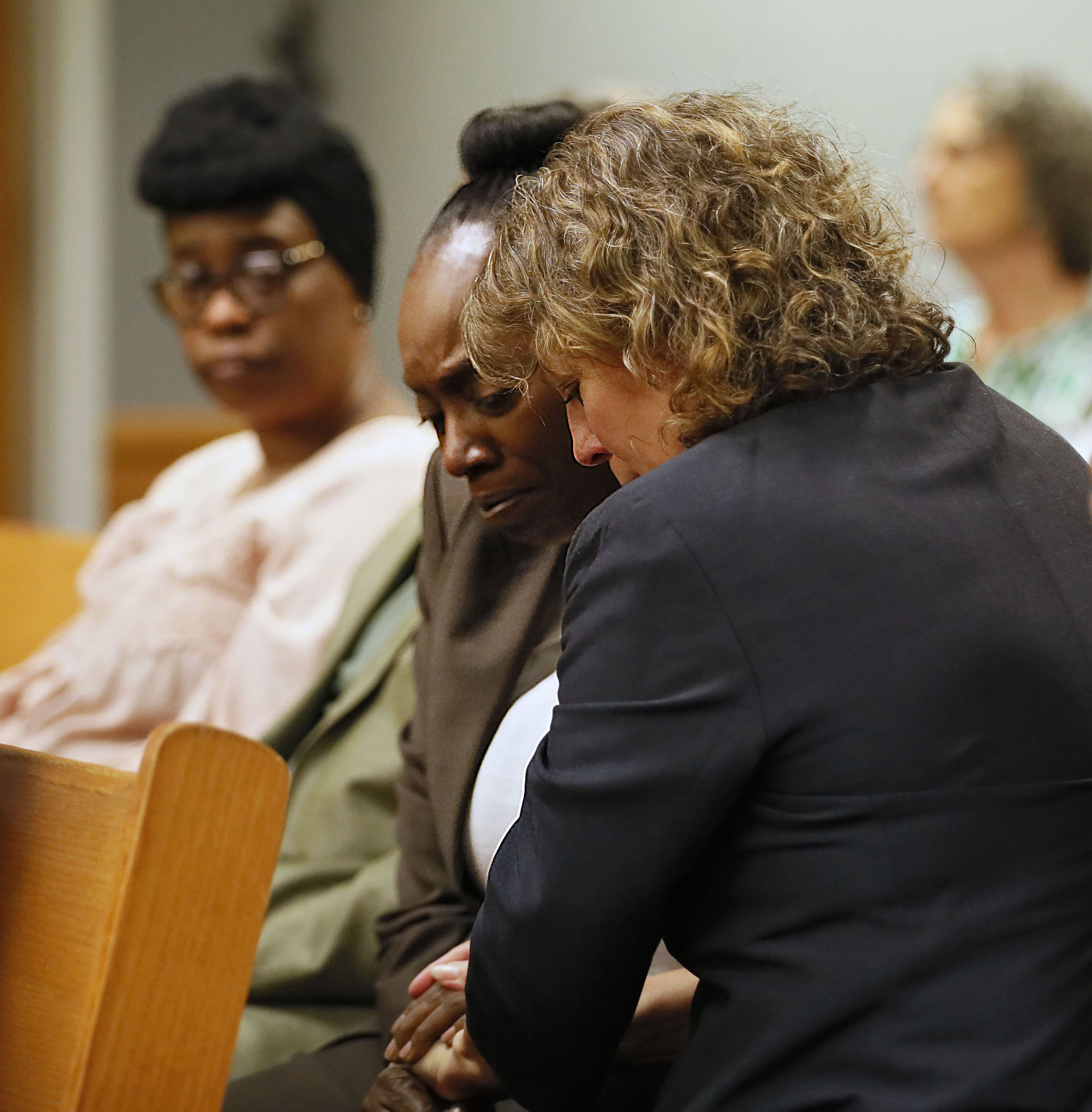 April 24, 2019 - Lawrenceville - Lisa Neal (right), who was Emani Moss' elementary school teacher, gives Robin Moss, Emani's grandmother, a hug after Neal testified during Day One of the Tiffany Moss death penalty trial. Tiffany Moss is accused of starving her stepdaughter Emani, and then trying to burn the corpse.