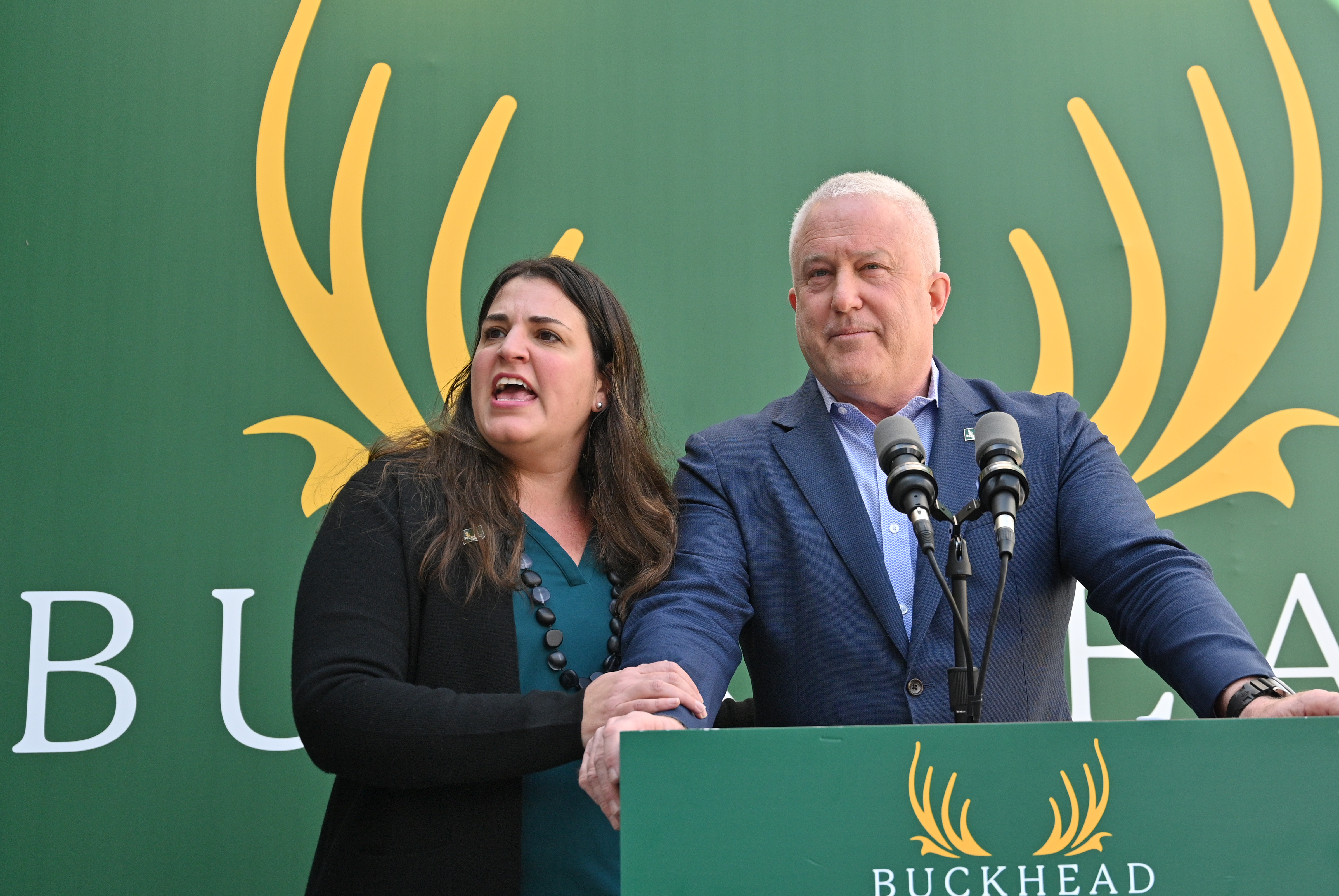 Leila Laniado (left), secretary of the Buckhead City Committee, holds Bill White, the group's chairman and CEO, as she speaks to members of the press during a news conference on Tuesday, February 18, 2022. (Hyosub Shin / Hyosub.Shin@ajc.com)
