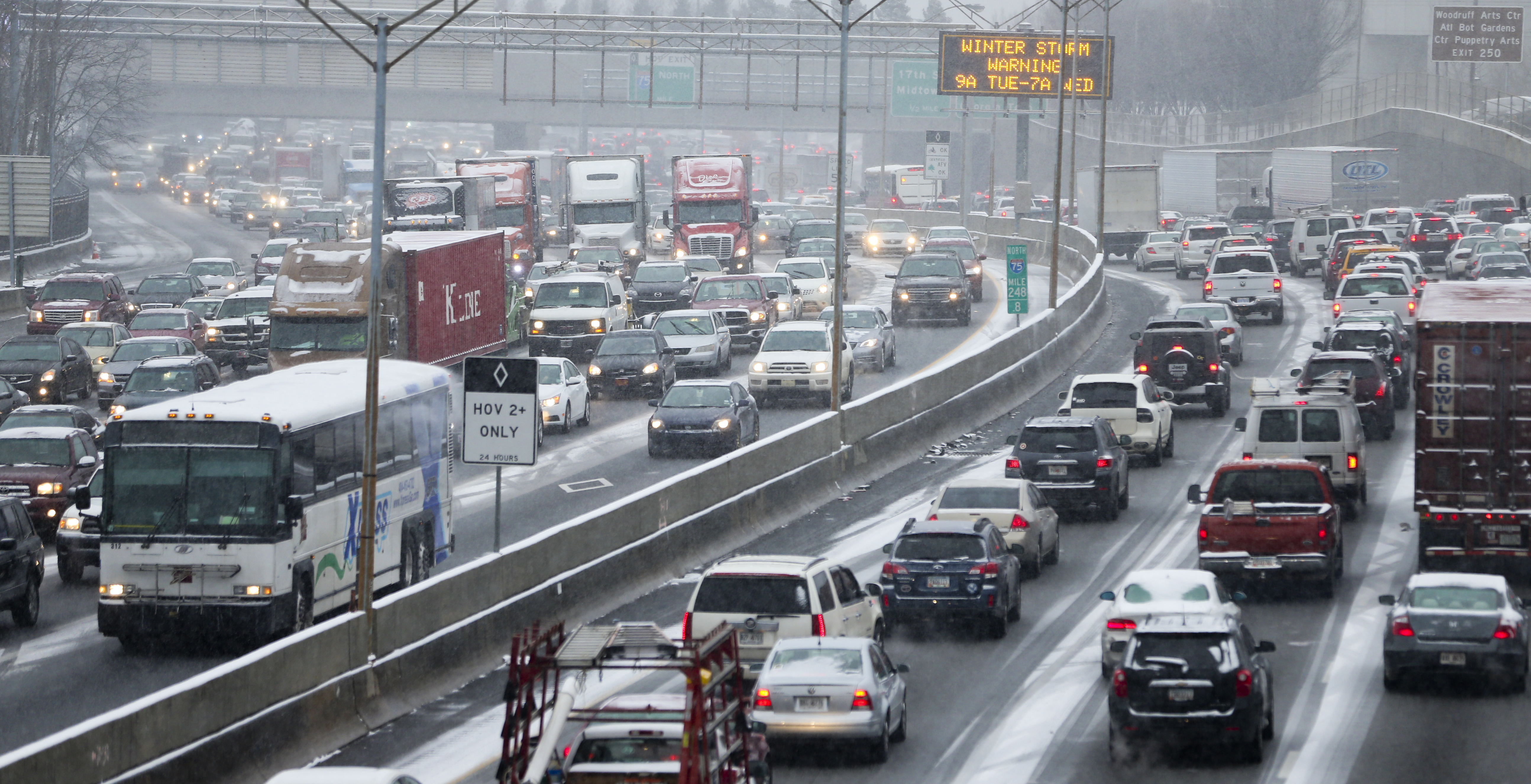Gridlock gripped the downtown connector and countless other highways, surface roads and side streets on Jan. 28, 2014 – known as SnowJam '14 – after school systems dismissed early and many employers let workers off at the same time. Note the electronic sign message: "Winter storm warning." JOHN SPINK / JSPINK@AJC.COM