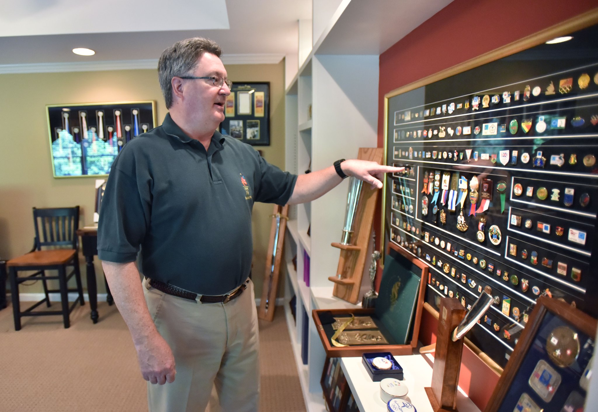 Scott Reed shows off a collection of Olympic pins at his home in Lilburn. Reed’s hobby took him to Sydney, Nagano, Japan; Lausanne, Switzerland; and London. HYOSUB SHIN / HSHIN@AJC.COM