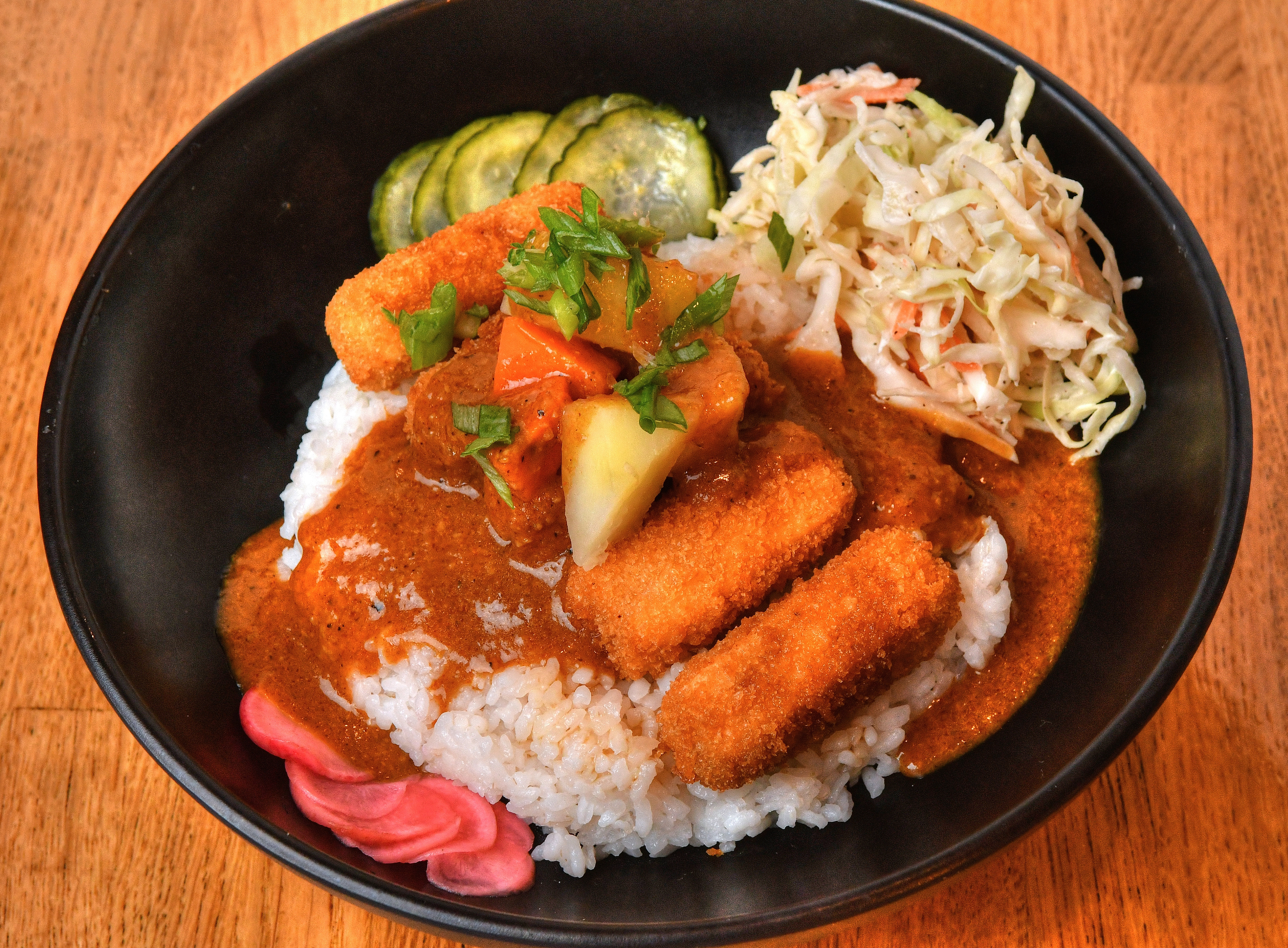 Curry Rice Bowl with Tenya fried tofu sticks, pickled red radish, sesame seeds and Japanese slaw. You also can get this dish with brined chicken tenders instead of the fried tofu. (Chris Hunt for The Atlanta Journal-Constitution)