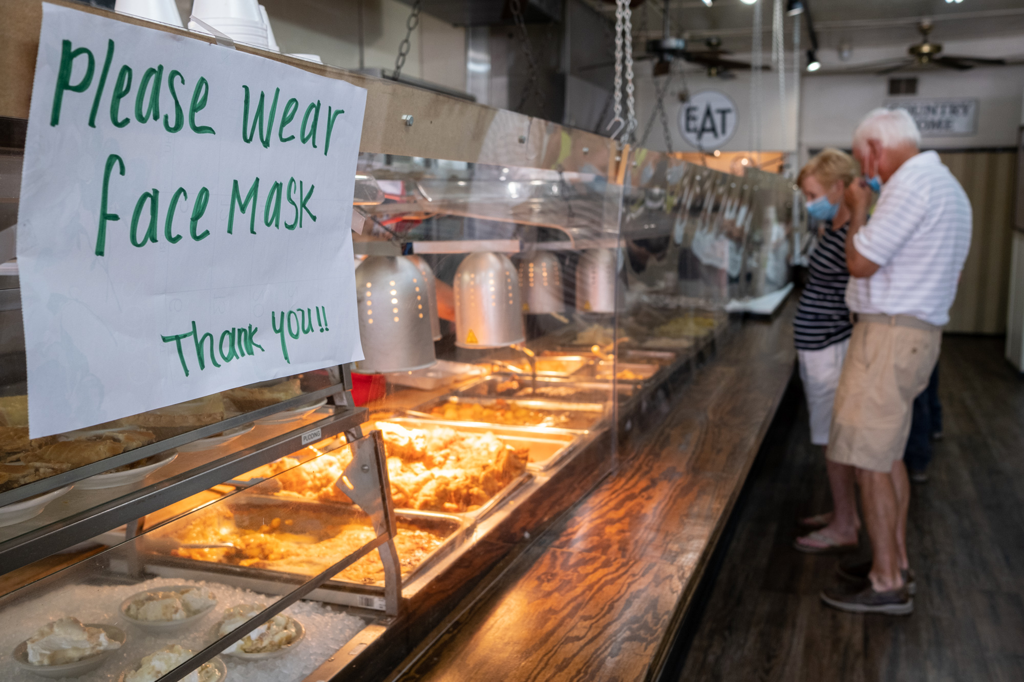200717-Tucker-Sheets of acrylic separate the food from the hungry lunch crowd at Matthews Cafeteria on Main Street in Tucker on Friday afternoon July 17, 2020. The dining institution, established in 1955, ask customers to wear masks, added the acrylic dividers, made separate entrance and exit doors and have drive-up service. Ben Gray for the Atlanta Journal-Constitution