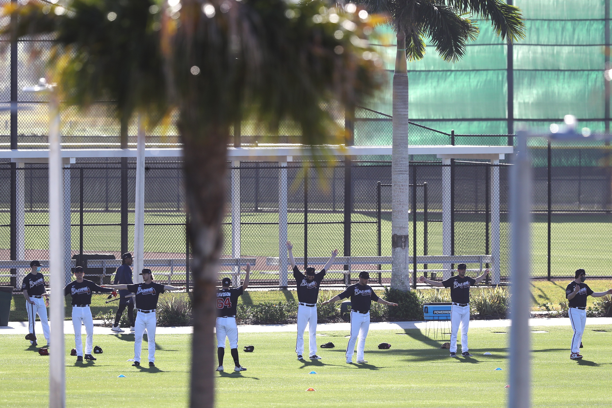 Braves pitchers loosen up in the early morning light on the agility field getting ready for another day of spring training at CoolToday Park on Saturday, Feb. 27, 2021, in North Port. Curtis Compton / Curtis.Compton@ajc.com”