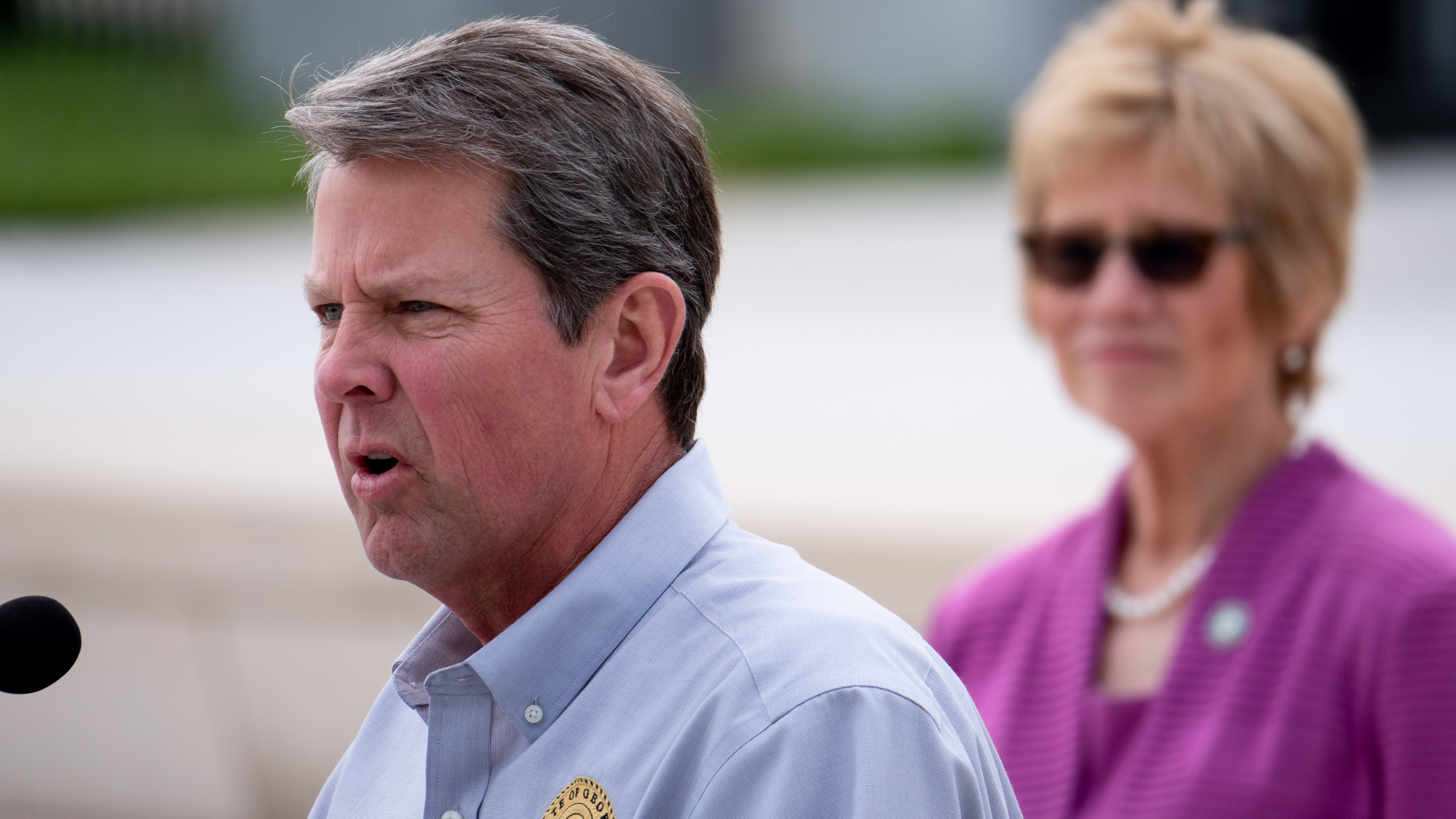 Gov. Brian Kemp talks about the coronavirus in Georgia during a press conference outside the state Capitol on Monday, April 13, 2020. Listening is Dr. Kathleen Toomey, commissioner of the Georgia Department of Public Health. (credit: Ben@BenGray.com for the Atlanta Journal-Constitution)