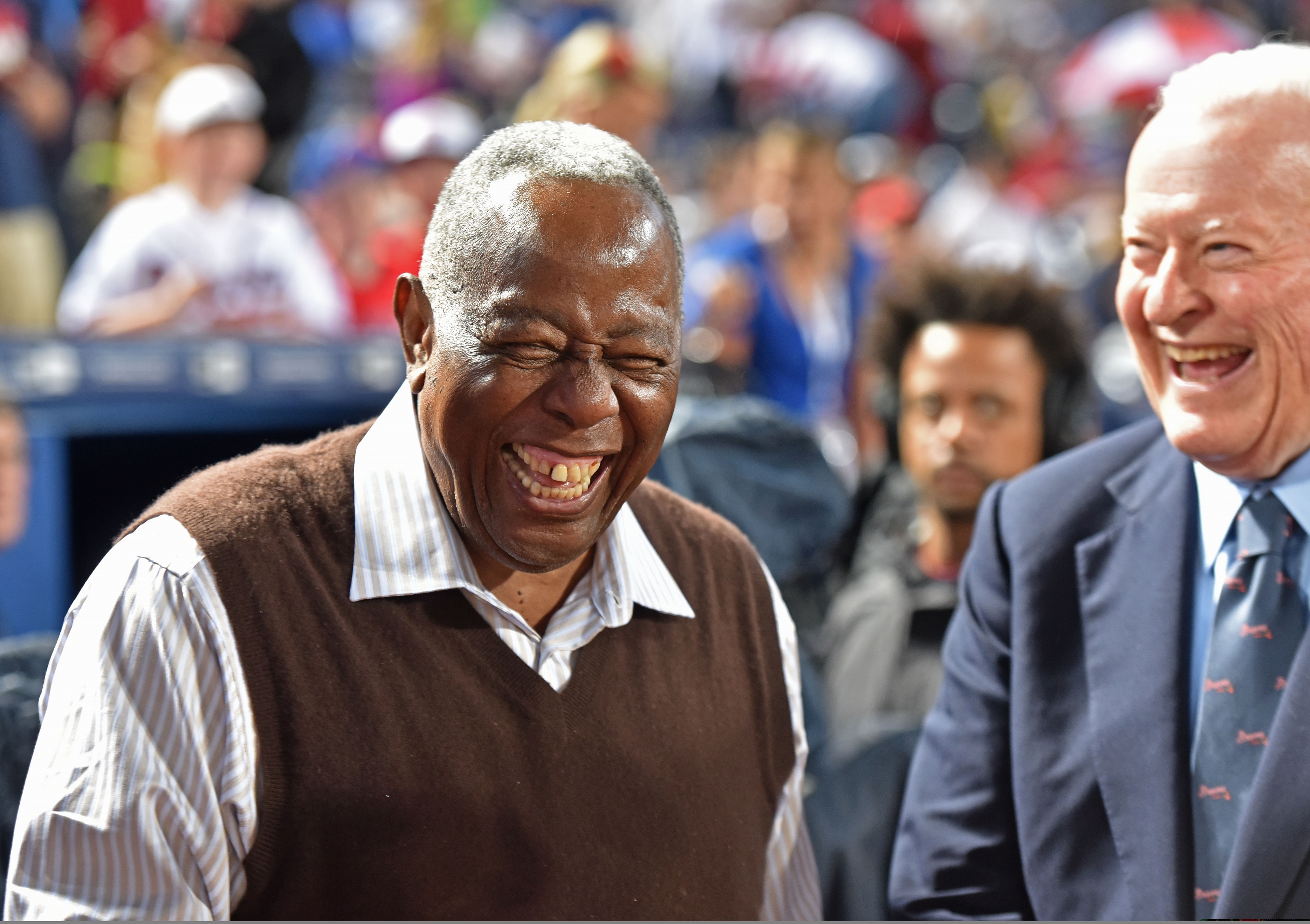 Bill Bartholomay, who frequently attended Braves games through last season, shares a laugh with Hank Aaron.