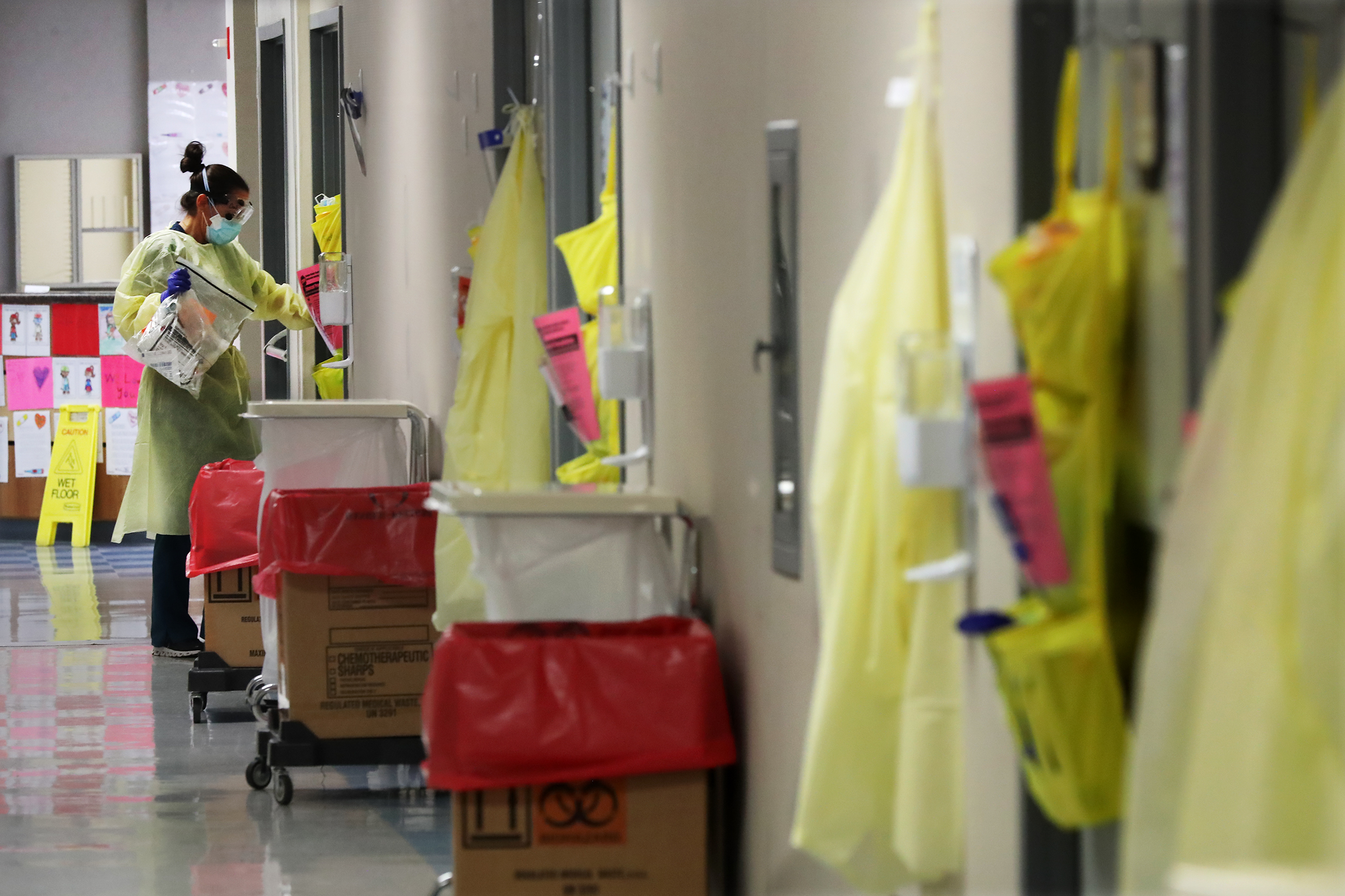 Ceri West, a registered nurse, enters one of the eight monoclonal antibody infusion rooms at Phoebe Putney Memorial Hospital in Albany on Monday. Curtis Compton / Curtis.Compton@ajc.com”