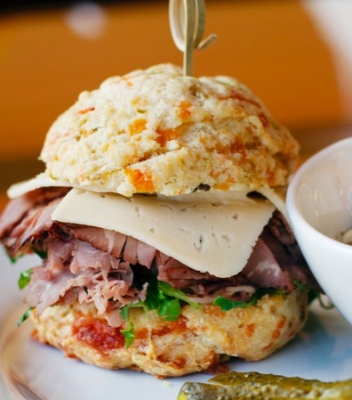 Hot lunchtime sconewiches include the scone of your choice, plus additions ranging from fried green tomatoes and pimento cheese to deli meats. Courtesy of Seven Sisters Scones