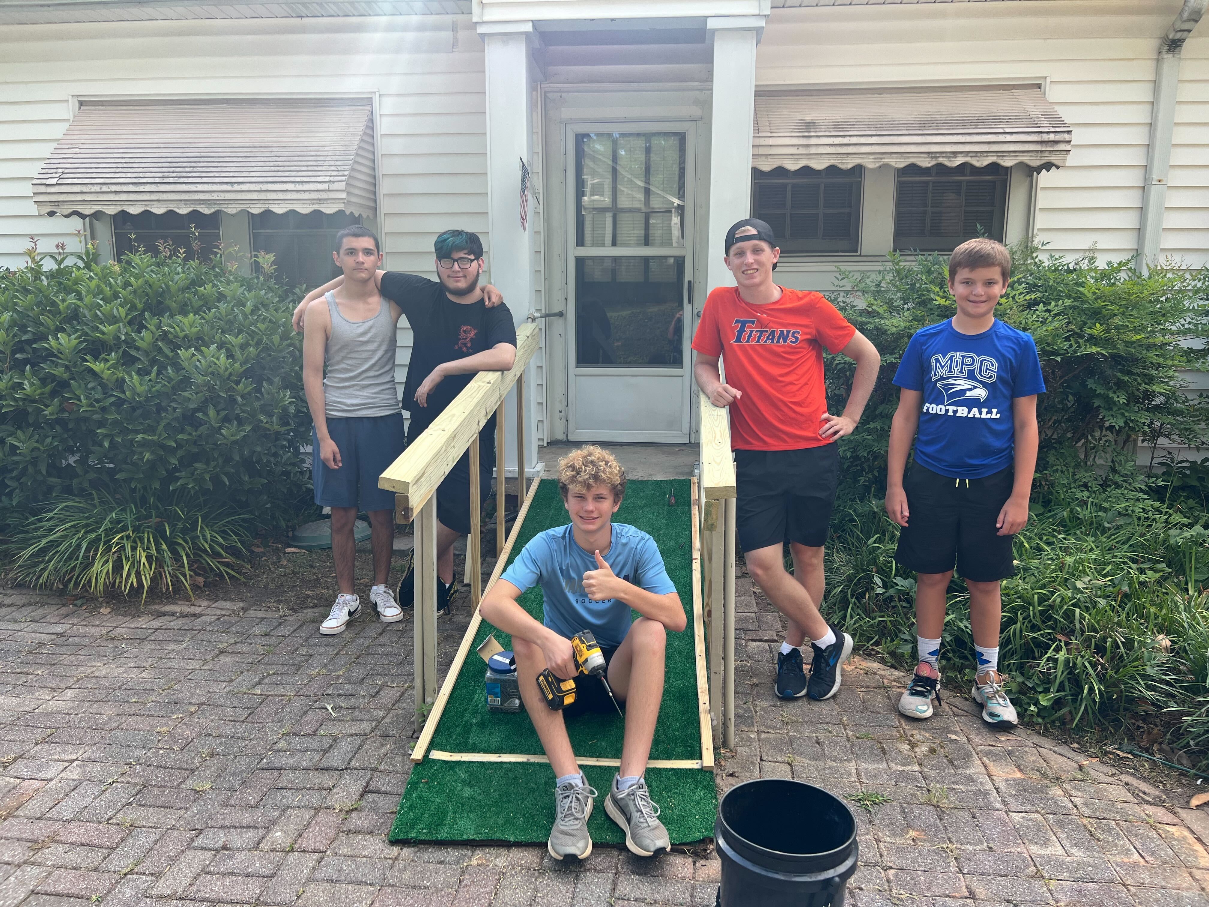 From left: Fabian Solano, Sean Salazar, Jackson Borders, Asa Brown and Major Jones help with yard work and repairs at the home of Robert Morrison, who was seriously injured by a hit-and-run driver while standing in his front yard Saturday.