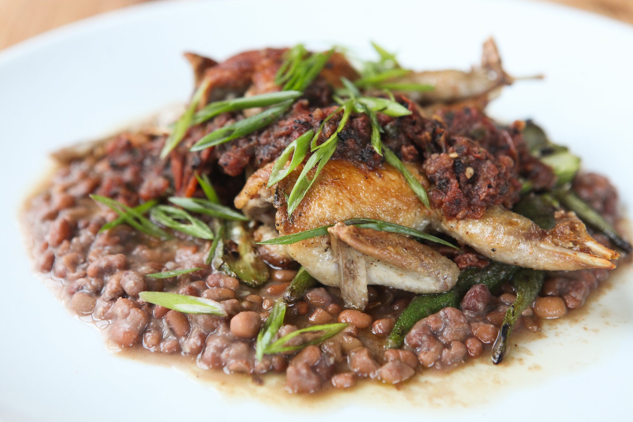 Quail with rancho gordo, and salsa molcajete at 8ARM. / Photo by Renee Brock/Special