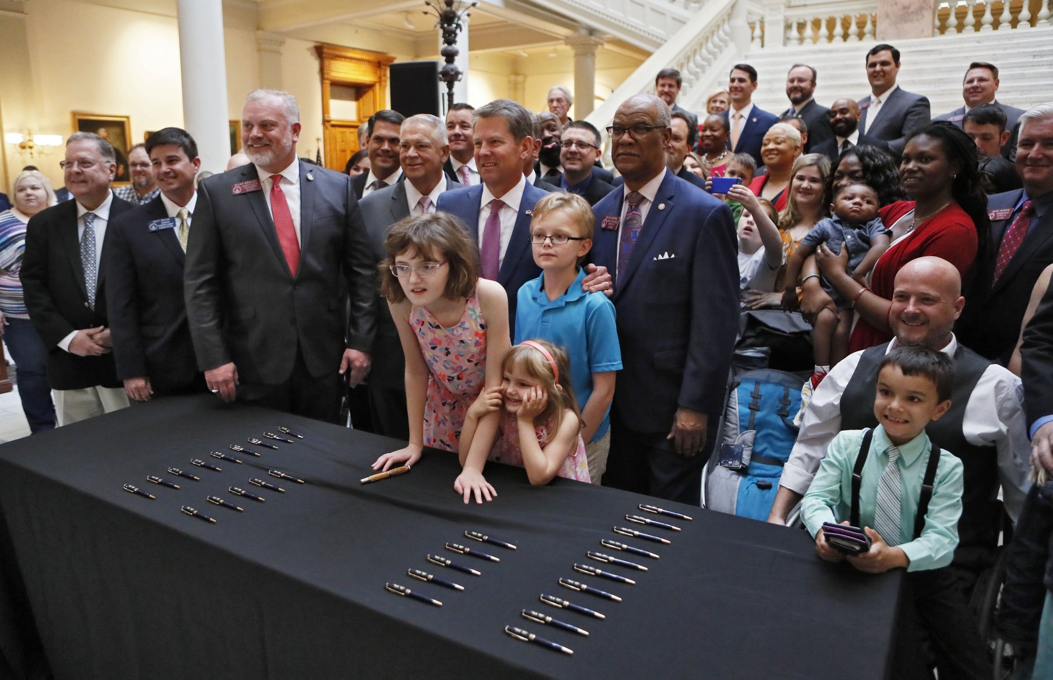 April 17, 2019 - Atlanta - Gov. Brian Kemp stood for a photo with medical marijuana users and advocates after the signing. Kemp signed HB 324 Wednesday, a bill that will allow medical marijuana oil to be sold in Georgia for the first time. The legislation would provide a way for the state's 9,000-plus medical marijuana patients to buy the drug they're already allowed to use. Bob Andres / bandres@ajc.com