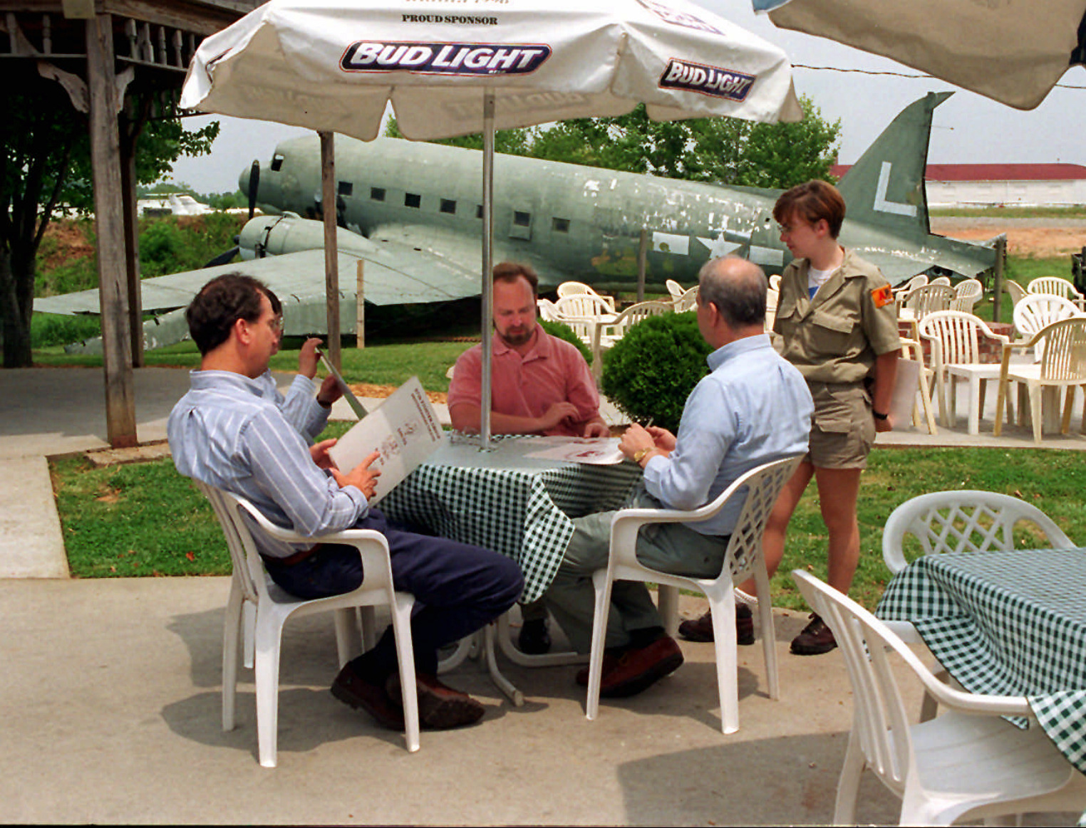 An old DC-3 can be seen behind patio diners at the 57th Fighter Group Restaurant. / AJC file photo