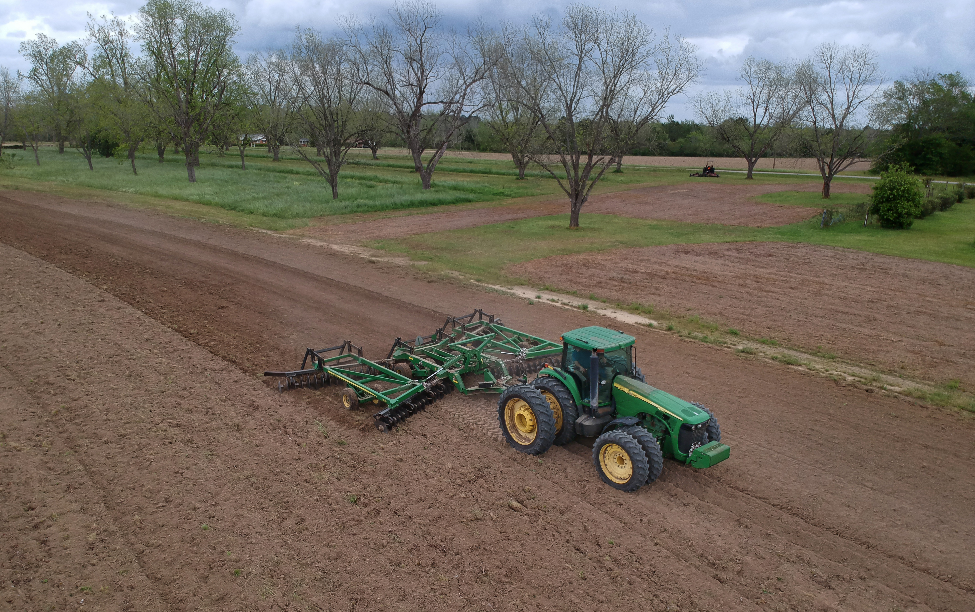 April 8, 2019 Meigs - Mike Hamm operates a John Deere utility tractor Hickey Farms for harrowing cotton field at Hickey Farms in Meigs on Monday, April 8, 2019. Congress' delay in finalizing an aid package for Hurricane Michael victims has had a real impact on the ground in Georgia. HYOSUB SHIN / HSHIN@AJC.COM
