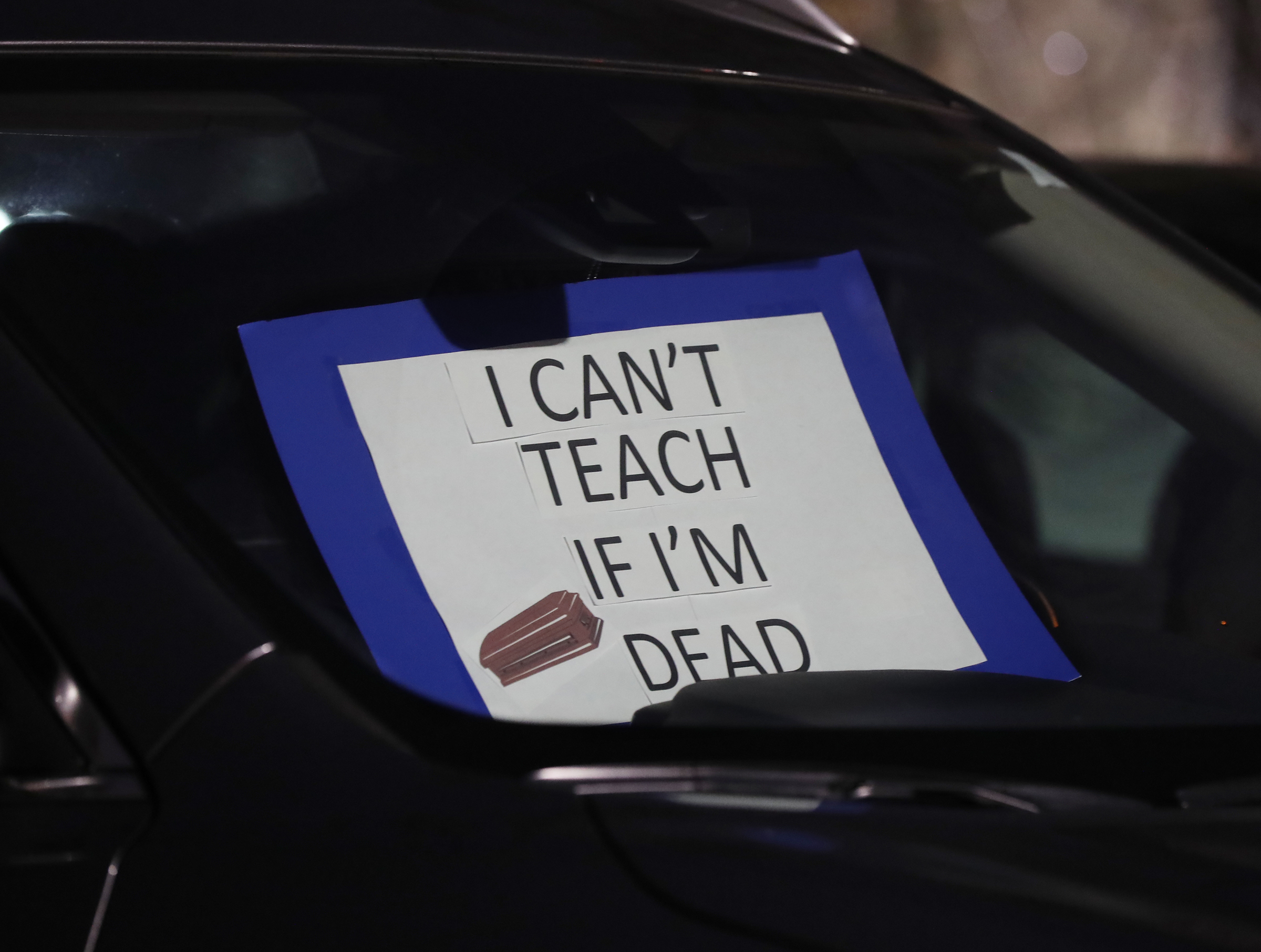 012121 Marietta: A teacher places a sign in her car while hundreds of Cobb County teachers and staff hold a protest in the parking lot during the school board meeting at the Cobb County School District's Offices on Thursday, Jan. 21, 2021, in Marietta. Cobb teachers are pressing the district for improved COVID-19 response. Curtis Compton / Curtis.Compton@ajc.com”