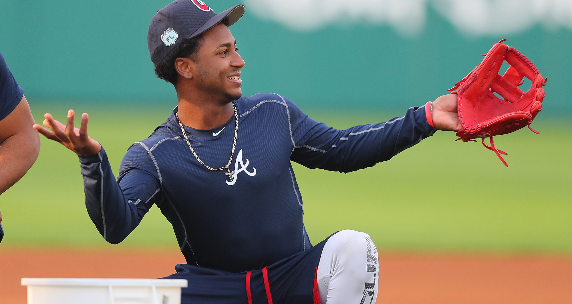 Atlanta Braves second baseman Ozzie Albies smiles while puting on