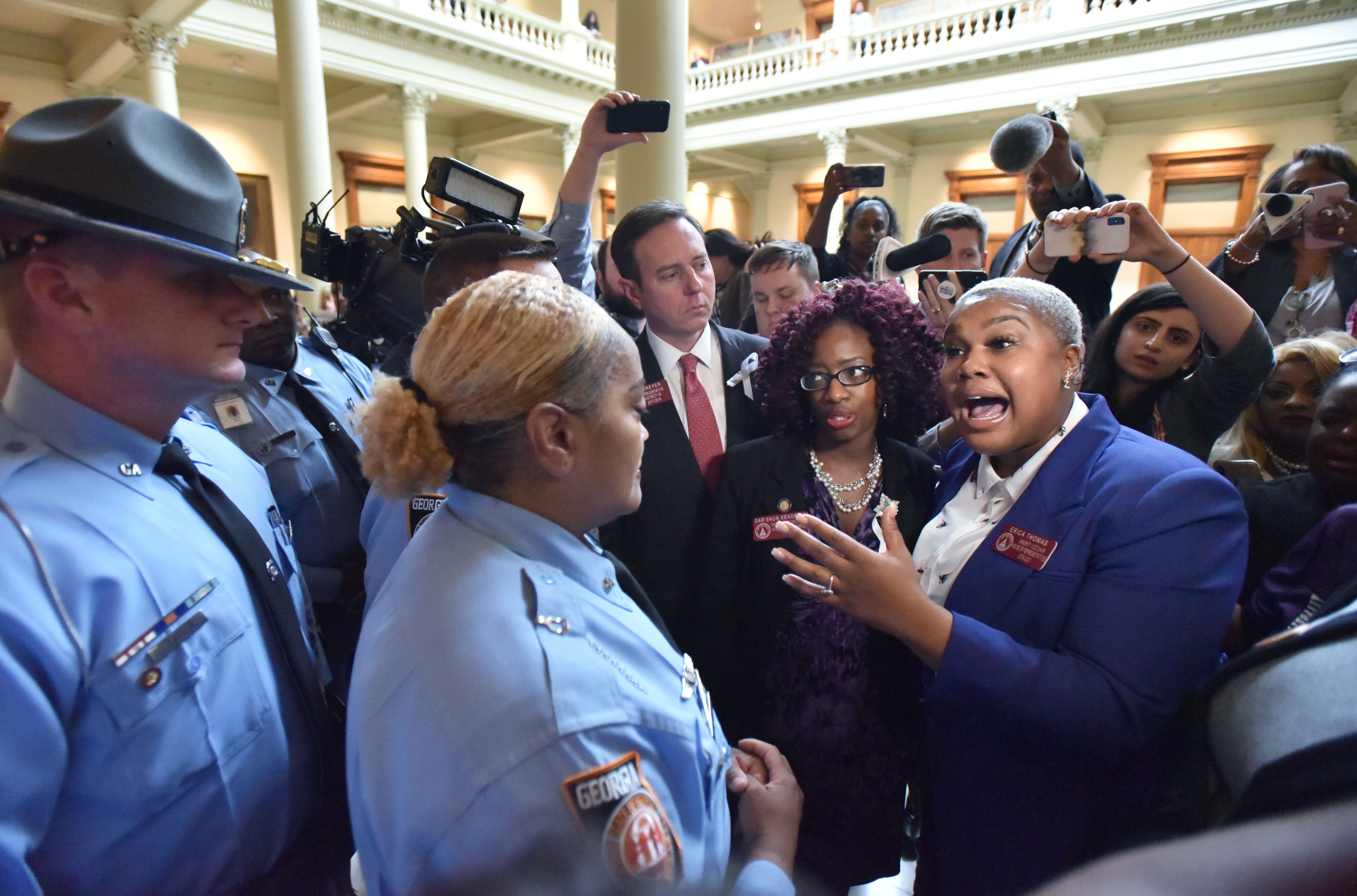 State Rep. Erica Thomas speaks with a Georgia State Patrol officer after the anti-abortion bill passed the House. HYOSUB SHIN / HSHIN@AJC.COM