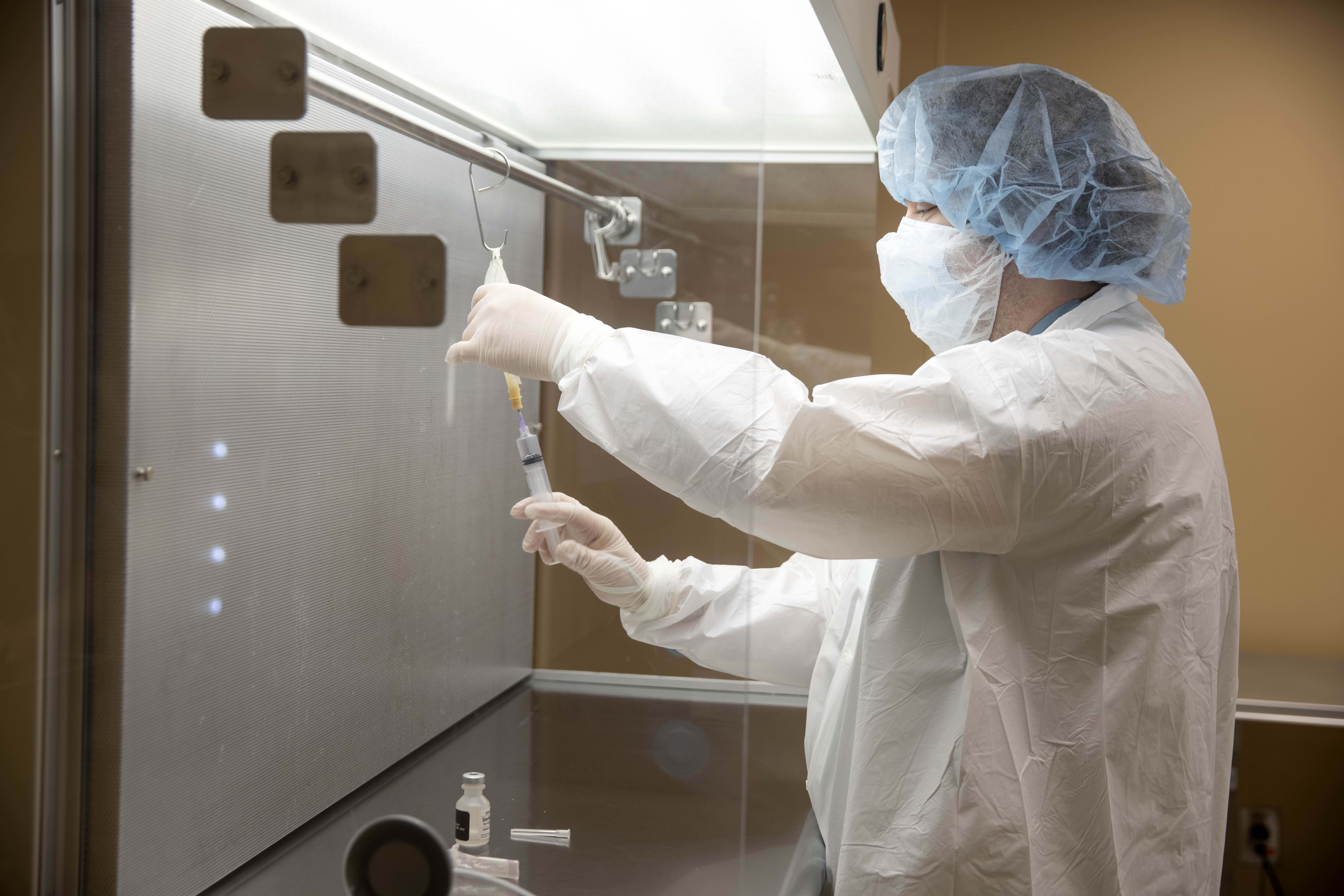 Floyd Medical Center pharmacy technician Jamison Christie prepares a dose of Monoclonal antibody treatment on Friday at Floyd Medical Center. (Ryan Smith photographer / Floyd Medical Center)