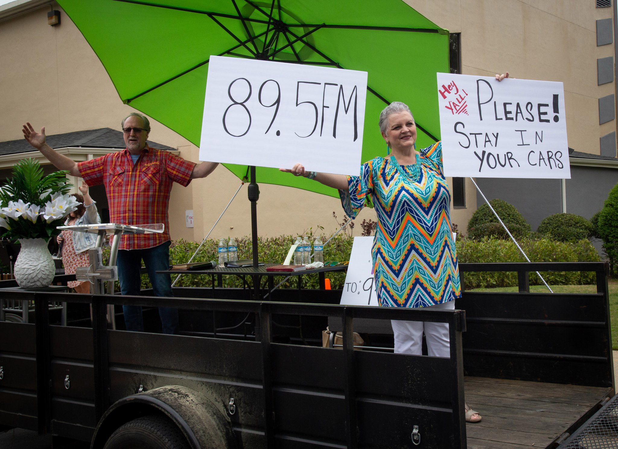Missy Osbon and her husband, Pastor Shell Osbon, greet the crowd at the beginning of the Drive-in church service at the Life Church Smyrna Assembly of God Sunday, April 5, 2020. STEVE SCHAEFER / SPECIAL TO THE AJC