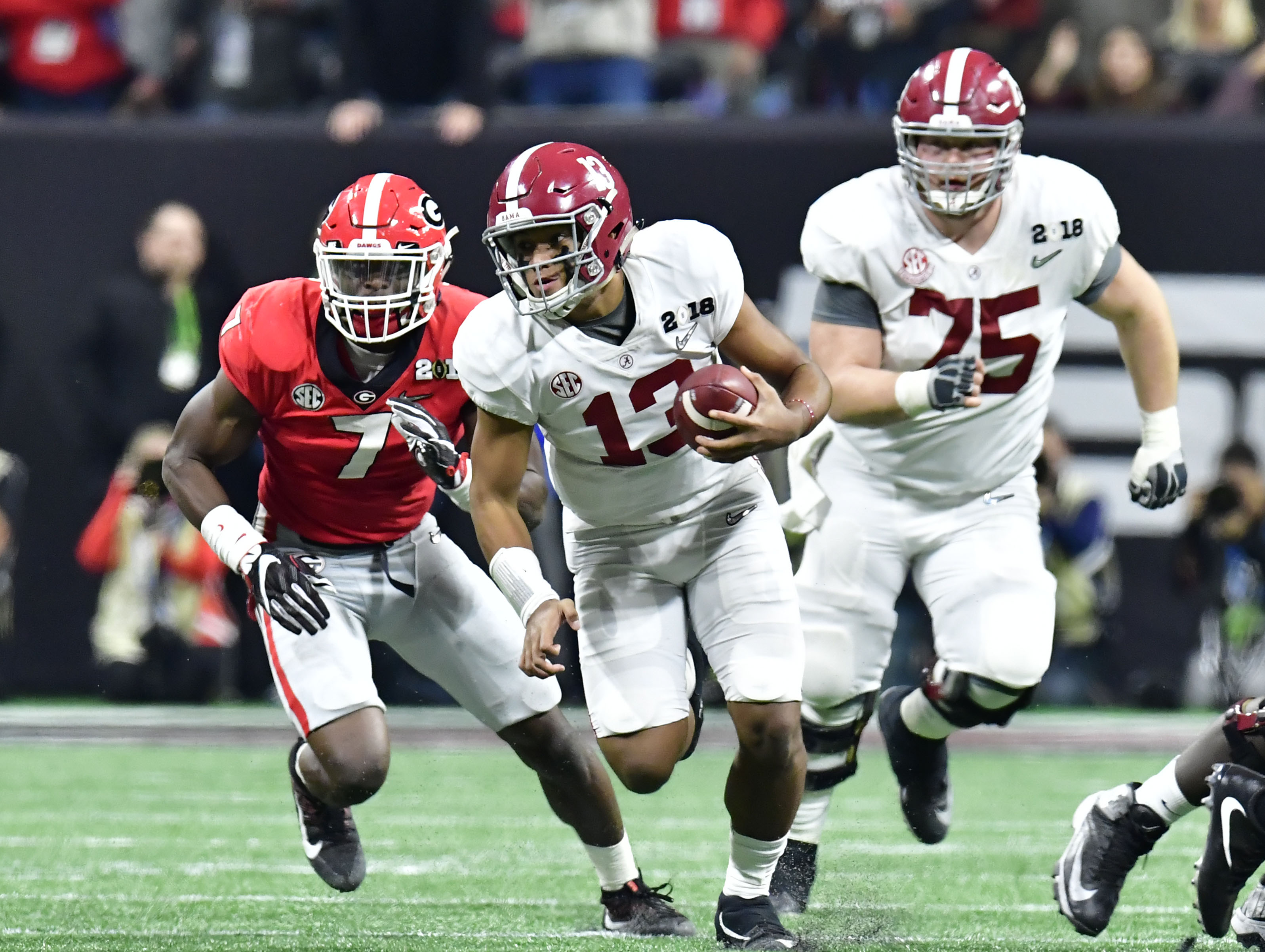 Tua Tagovailoa Alabama Crimson Tide Unsigned White Jersey Holding Up  National Championship Trophy Photograph