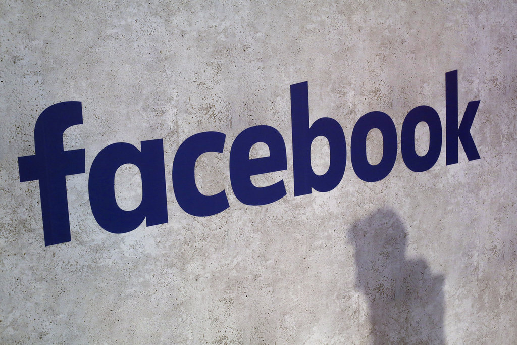 File - This Jan. 17, 2017, file photo shows a Facebook logo being displayed in a start-up companies gathering at Paris' Station F, in Paris. Facebook is on the offensive to try to contain swirling concerns about how it protects the data of its 2.2 billion members. As CEO Mark Zuckerberg prepares to face Congress on Tuesday, April 10, 2018, and the company rolls out new privacy rules, the social media juggernaut is facing the most serious challenge in its 14-year-history and seeking to maintain peopleâs trust and avoid a user exodus.(AP Photo/Thibault Camus, File)