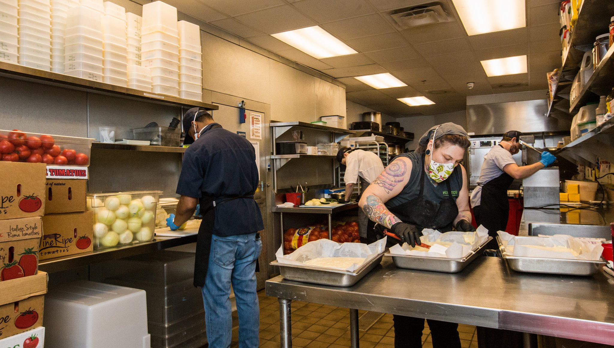 In the kitchen at Superica, pastry chef Daniela Canada, center, prepped tres leches cake while her colleagues prepped vegetables on March 25 for takeout orders. The next day, the restaurant shut down completely. (Jenni Girtman for The Atlanta Journal Constitution)