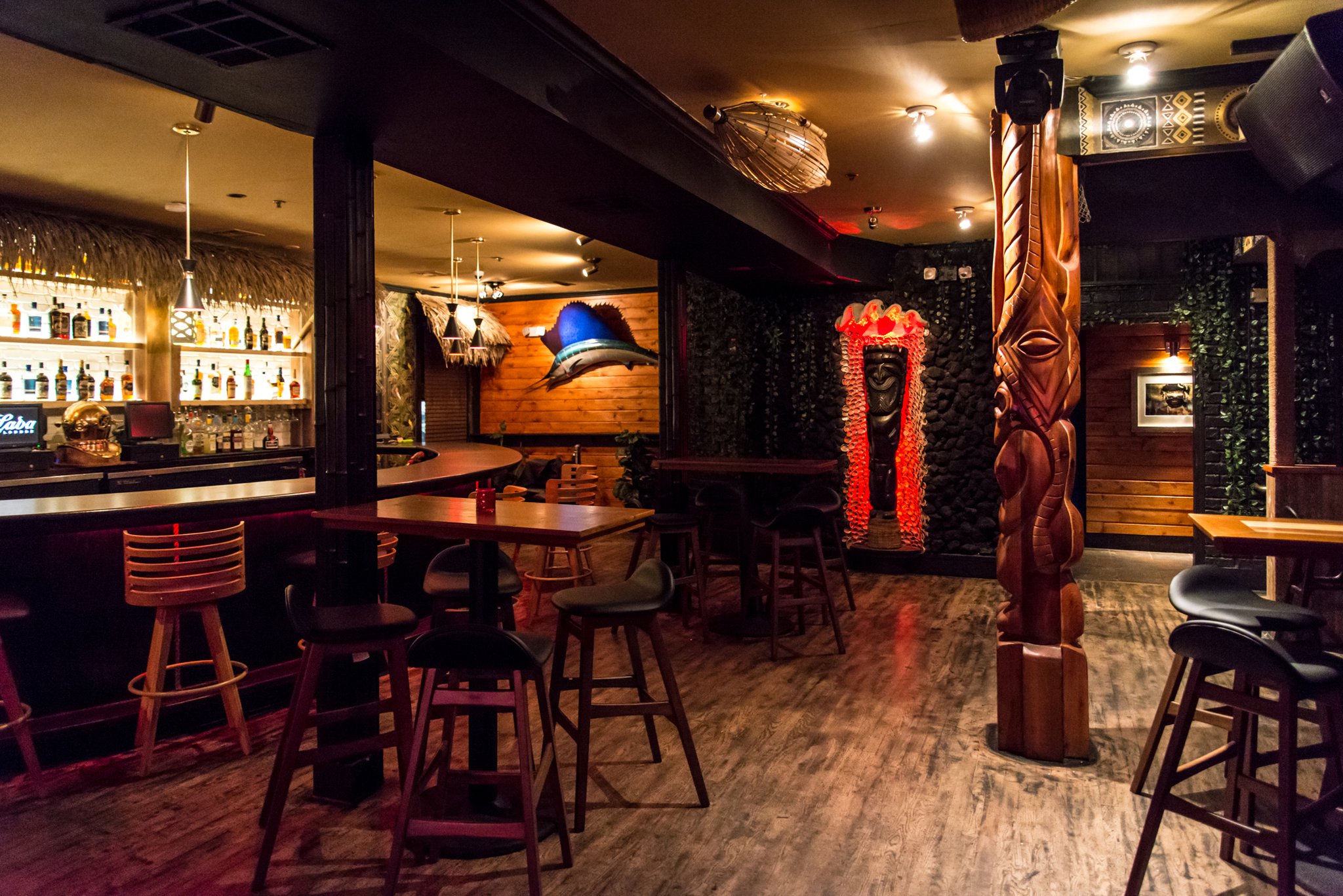 Tiki Tango “Main Deck” bar with Tiki idols hand-carved by Frank Simotics. Photo credit- Mia Yakel.