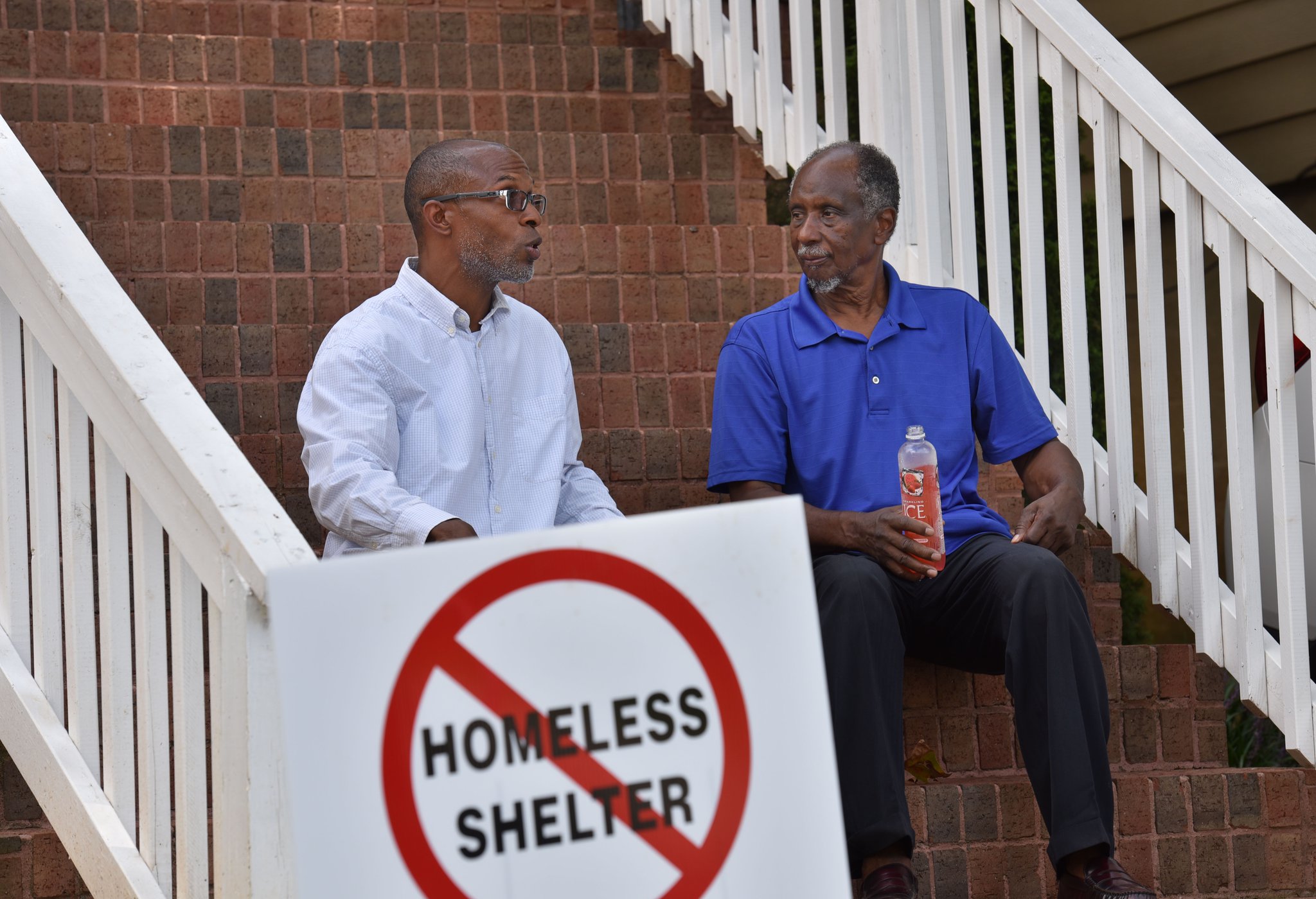 In this August 2016 photo, Devon Holloway (left) and former state Rep. Douglas Dean talk outside Holloway’s home in the Pittsburgh neighborhood of Atlanta. Holloway co-founded PittsburghAtl Homeowners United, a group of relatively new Pittsburgh residents. Dean, meanwhile, heads the Pittsburgh Neighborhood Association that consists mostly of longtime residents.