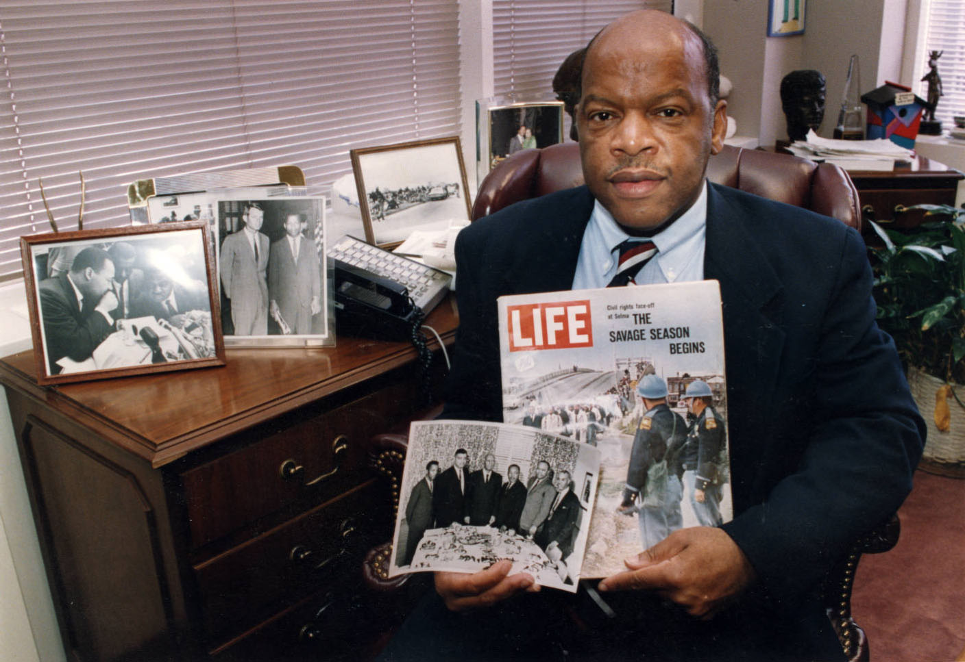 Rep. John Lewis shows off some memorabilia in his Atlanta office in the Equitable Building, in 1994. (Kimberly Smith / AJC Archive at GSU Library AJCP452-146f)