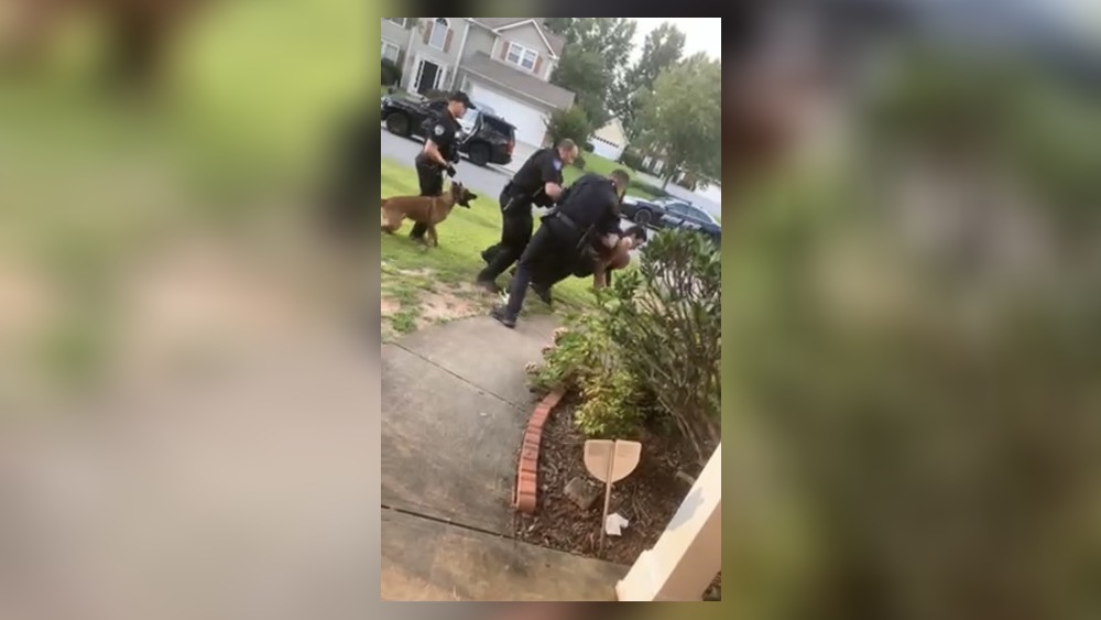 Attorneys for an Alpharetta man said he was restrained when he was bitten repeatedly by a police K-9 outside his home.