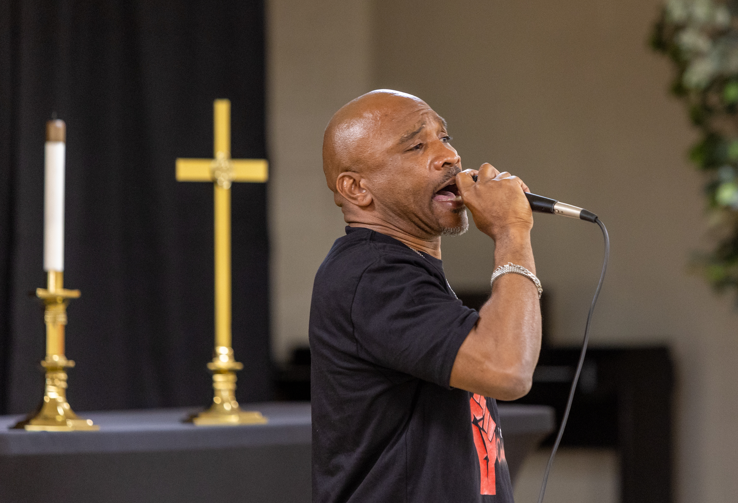 Kenneth Miller, a Fulton County high school athletic director, speaks at a rally for him at East Point First Mallalieu United Methodist Church on March 17, 2022. Miller is appealing a suspension after he was accused of pushing a student during a campus search for a handgun. He has been on paid leave from his post at Tri-Cities High School since shortly after the August incident. (Jenni Girtman for The Atlanta Journal-Constitution)