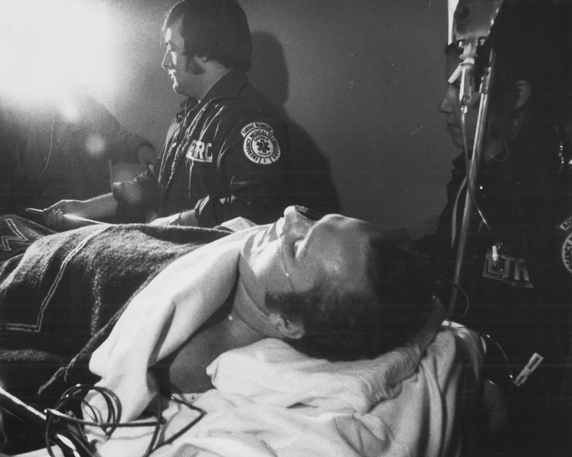 Hustler magazine publisher Larry Flynt is carried into Emory Hospital by EMTs on March 9, 1978. Flynt, shot in the abdomen, was taken on the day of the shooting, March 6, to Button Gwinnett Hospital, where he underwent surgery. Doug Campbell, Flynt's personal administrator, said "Physically, he's in a precarious position right now and he's aware of that."