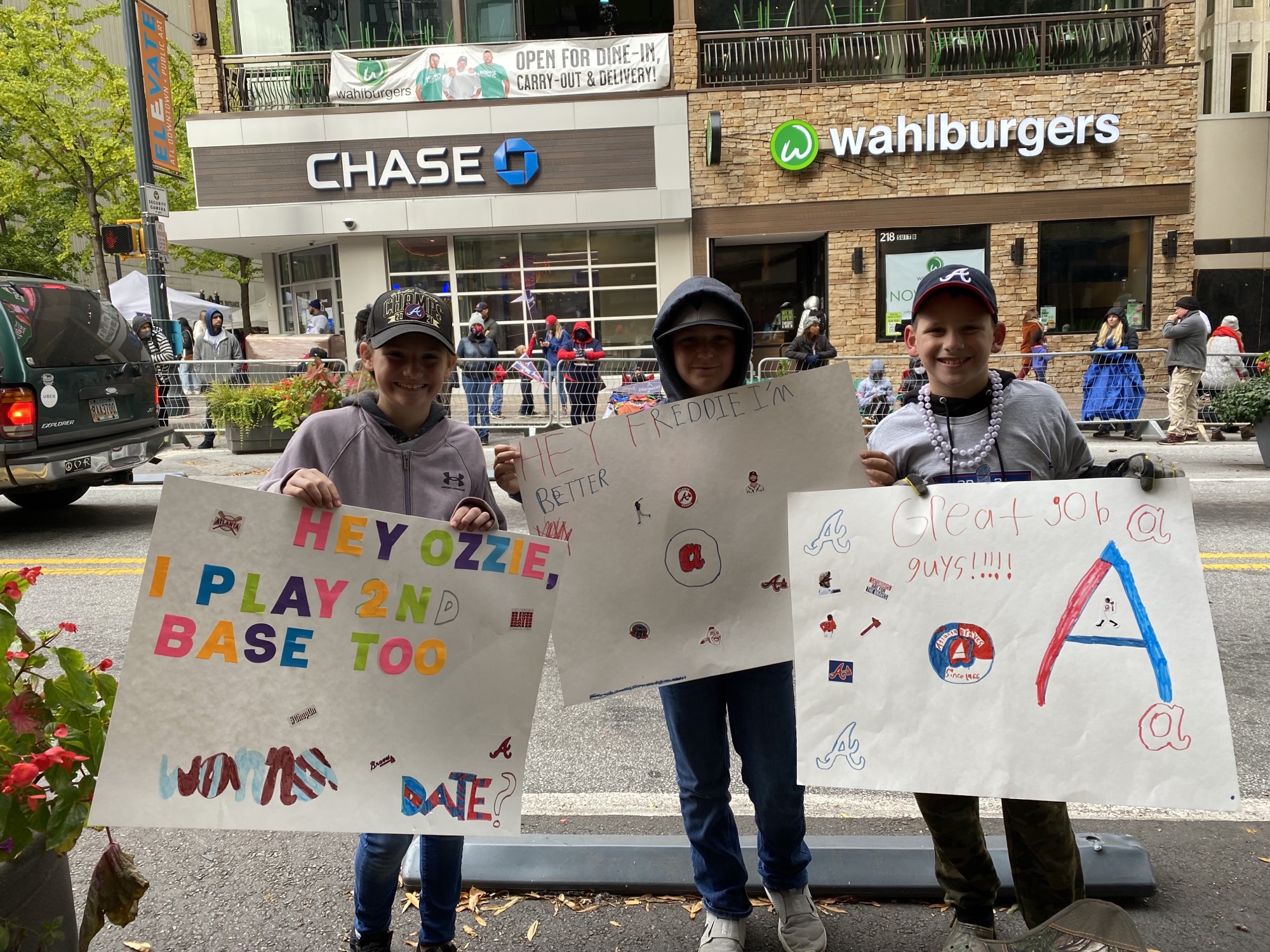 Olivia Rose, Channing Pittman, 10, and Cooper Rose, 11, with their homemade signs cheering on the Atlanta Braves Friday. Olivia and Cooper are grandchildren of AJC community contributor Cathy Lussiana.