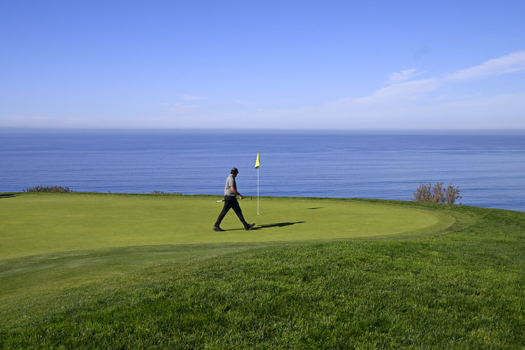 Phil Mickelson walks on the green on the fourth hole of the South Course at Torrey Pines during the first round of the Farmers Insurance Open golf tournament, Wednesday, Jan. 26, 2022, in San Diego. (AP Photo/Denis Poroy)