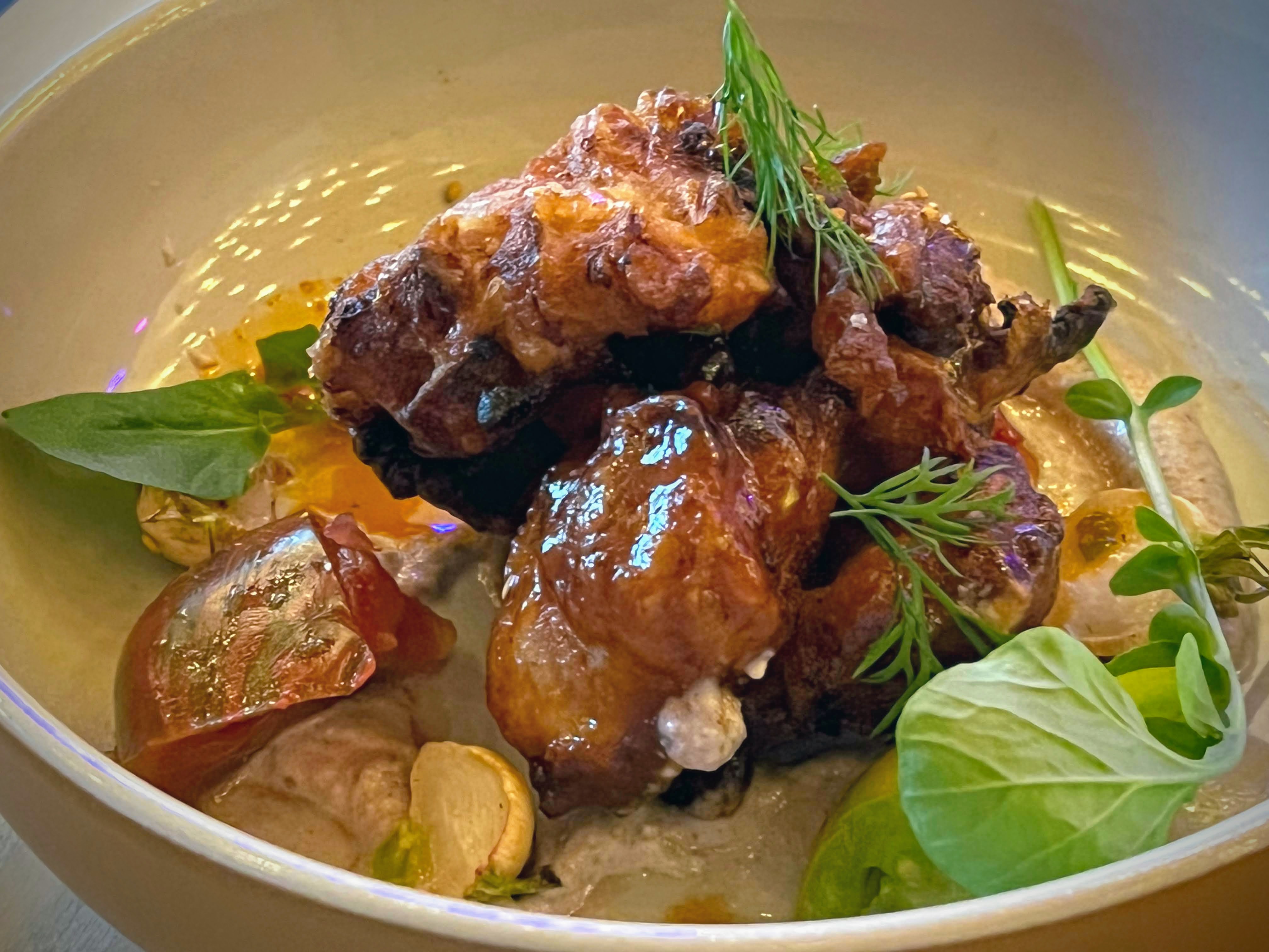 Sweet and sour chicken at Little Bear is served with a sauce featuring fresh tomatoes, as well as a rich pecan tahini. Henri Hollis/henri.hollis@ajc.com