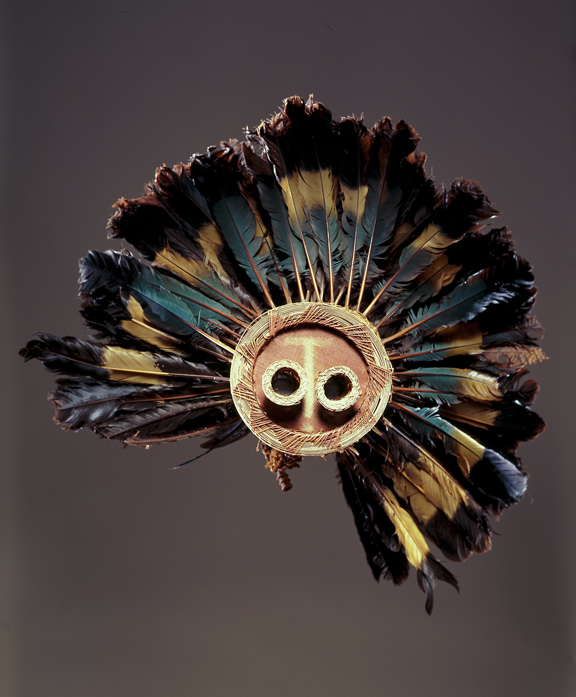 This is a Pende mask from the Democratic Republic of the Congo. The piece was made in the late-19th or early-20th century, of great blue turaco feathers, fiber, and wood. It's part of the High Museum of Art's African Art collection.