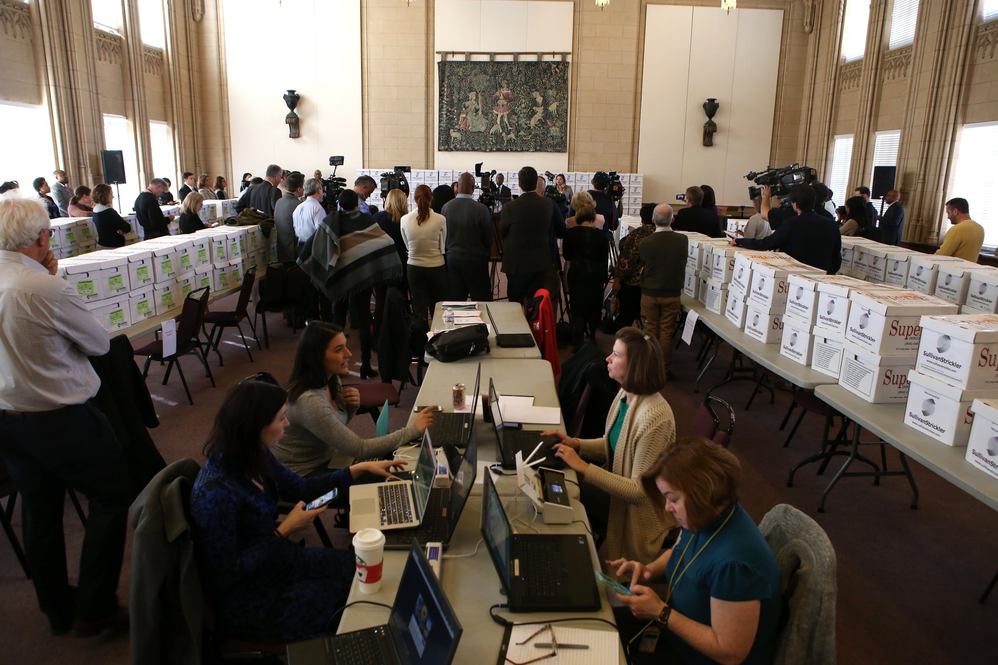Journalists prepare to examine records held in hundreds of boxes inside the old City Council chambers at City Hall in February 2017. Then-Mayor Kasim Reed announced the release of more than 1.4 million pages of records responsive to the federal bribery investigation. (HENRY TAYLOR / HENRY.TAYLOR@AJC.COM)