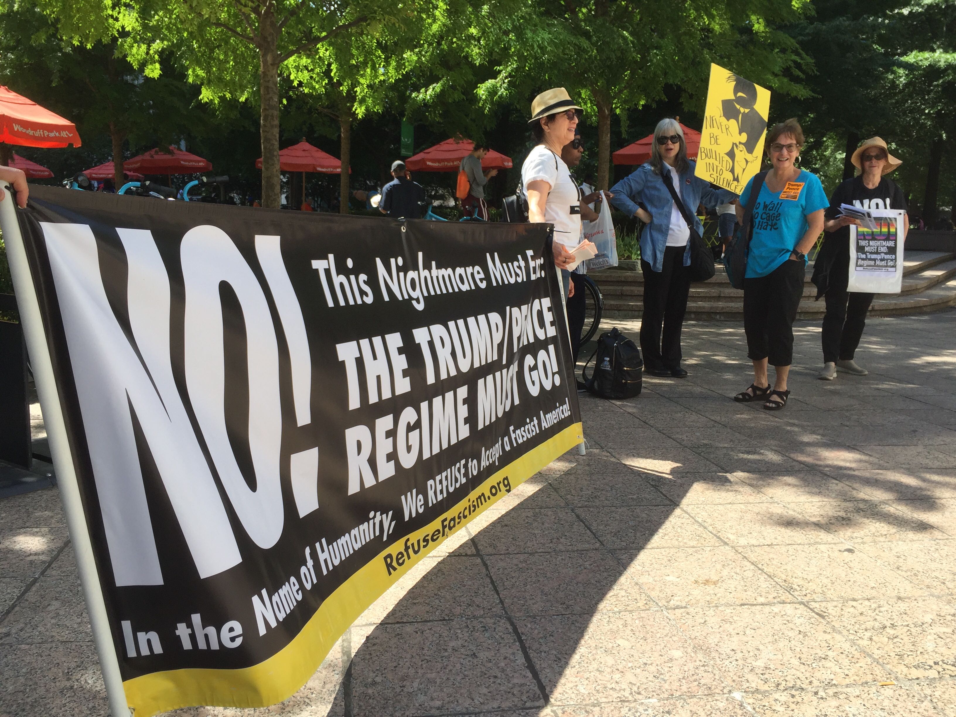 Protesters begin to gather in Woodruff Park in advance of President Donald Trump's visit to Atlanta on Wednesday afternoon.