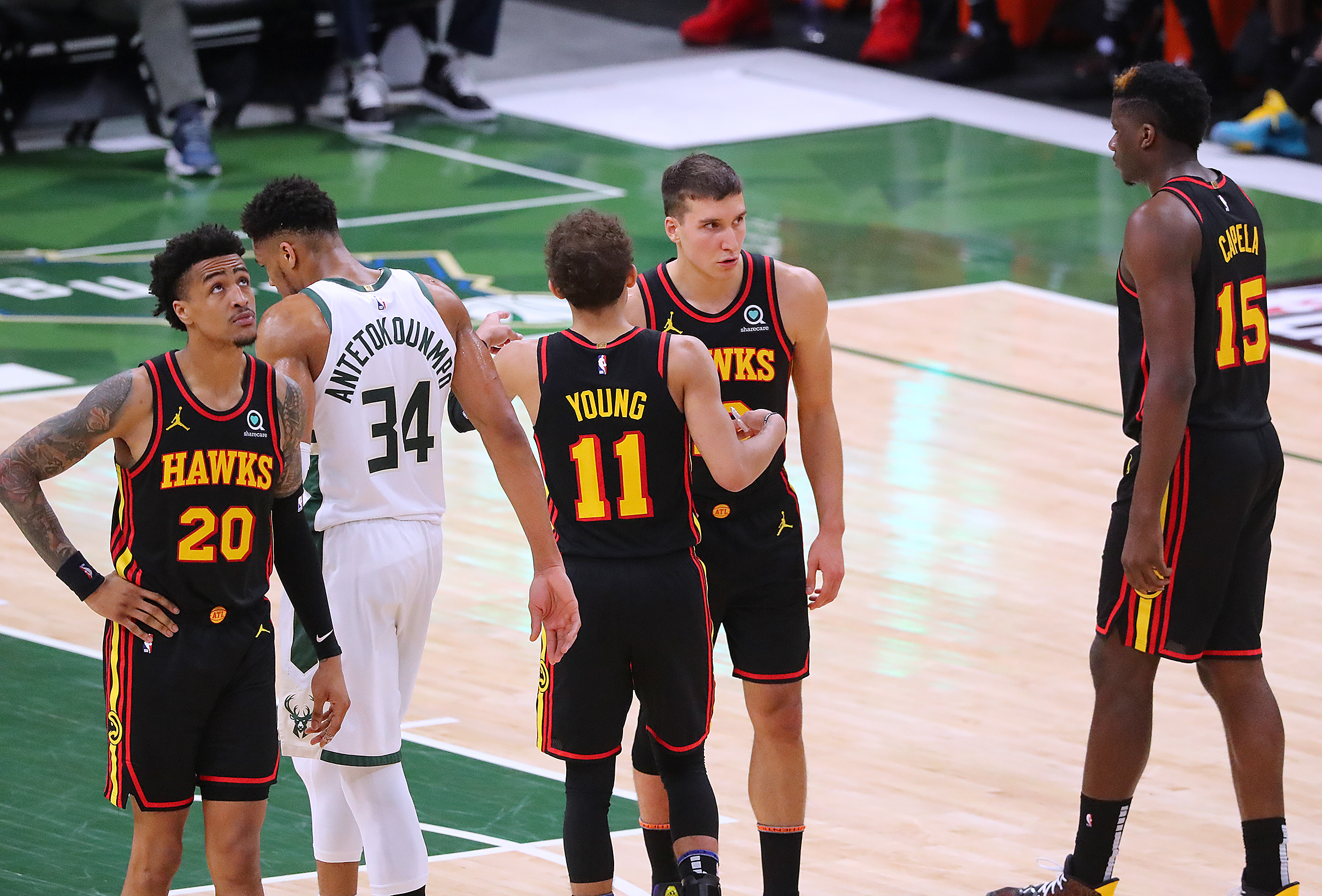 Hawks players John Collins, Trae Young, Bogdan Bogdanovic, and Clint Capela look for answers. “Curtis Compton / Curtis.Compton@ajc.com”