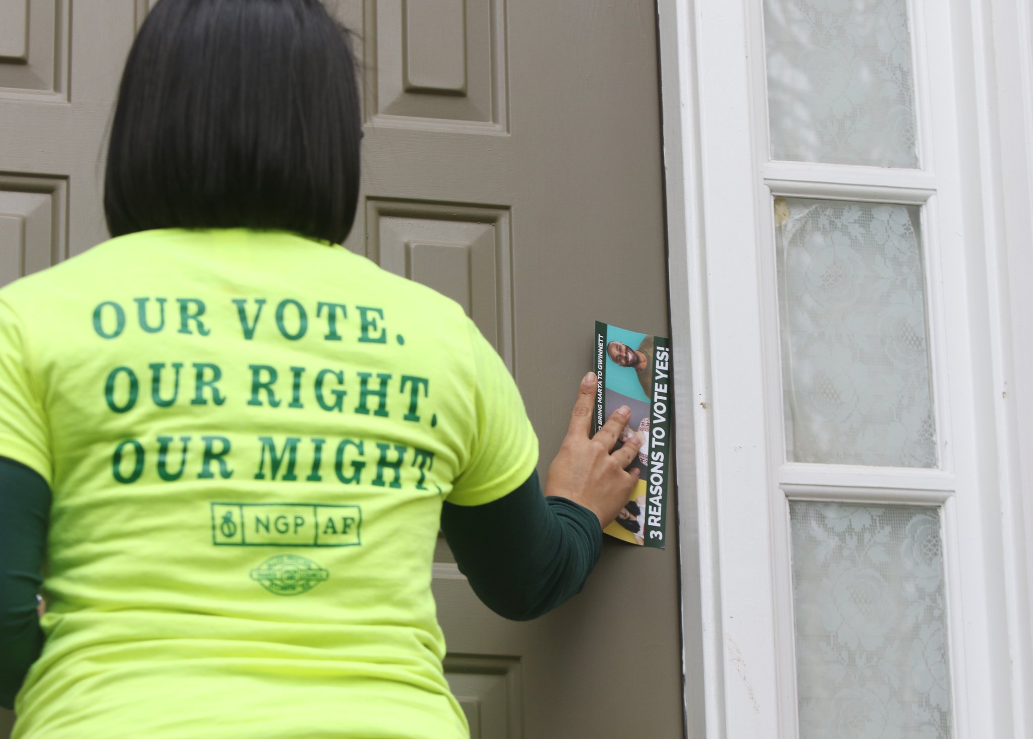 Michelle Sanchez with the New Georgia Project Action Fund leaves information in support of the Gwinnett County MARTA referendum while canvassing on February 22, 2019 in Norcross.