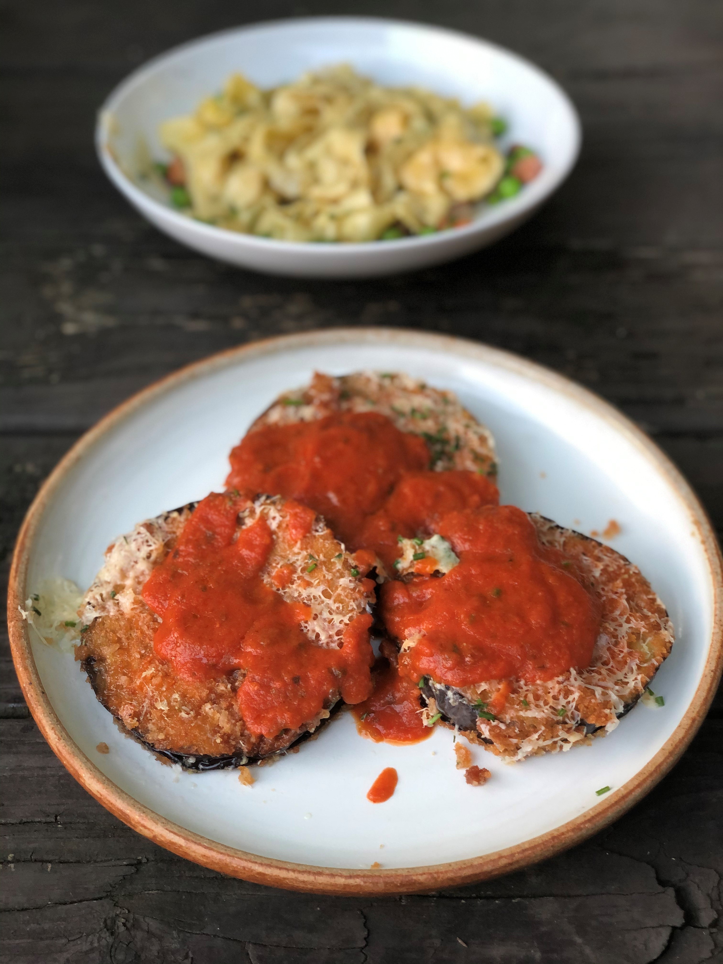 Up front is A Mano’s eggplant parmesan, with carbonara in the background. CONTRIBUTED BY WENDELL BROCK
