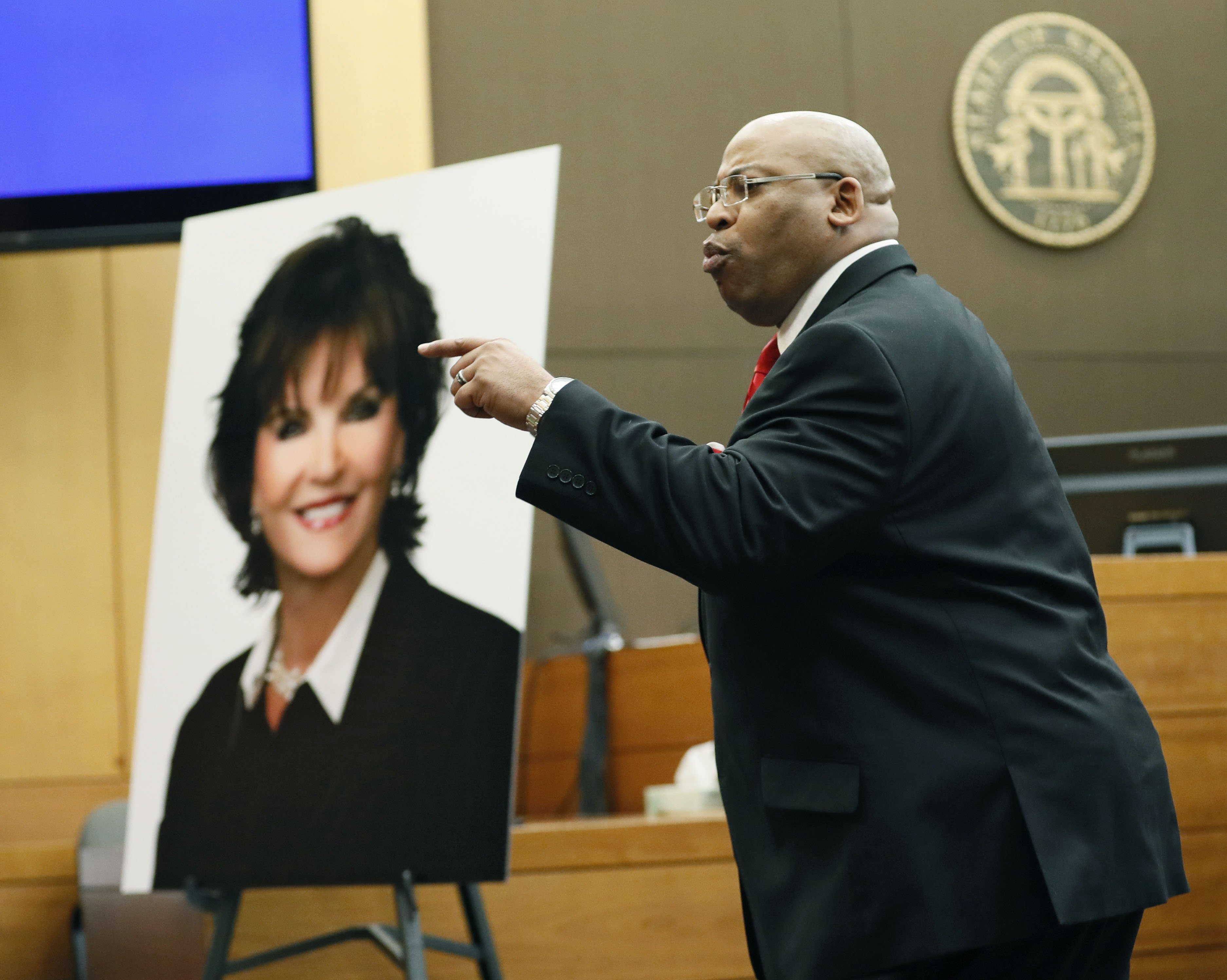 4/17/18 - Atlanta - Chief Assistant District Attorney Clint Rucker, with a photo of Diane McIver behind him, makes closing arguments for the prosecution today during the Tex McIver murder trial at the Fulton County Courthouse. Bob Andres bandres@ajc.com