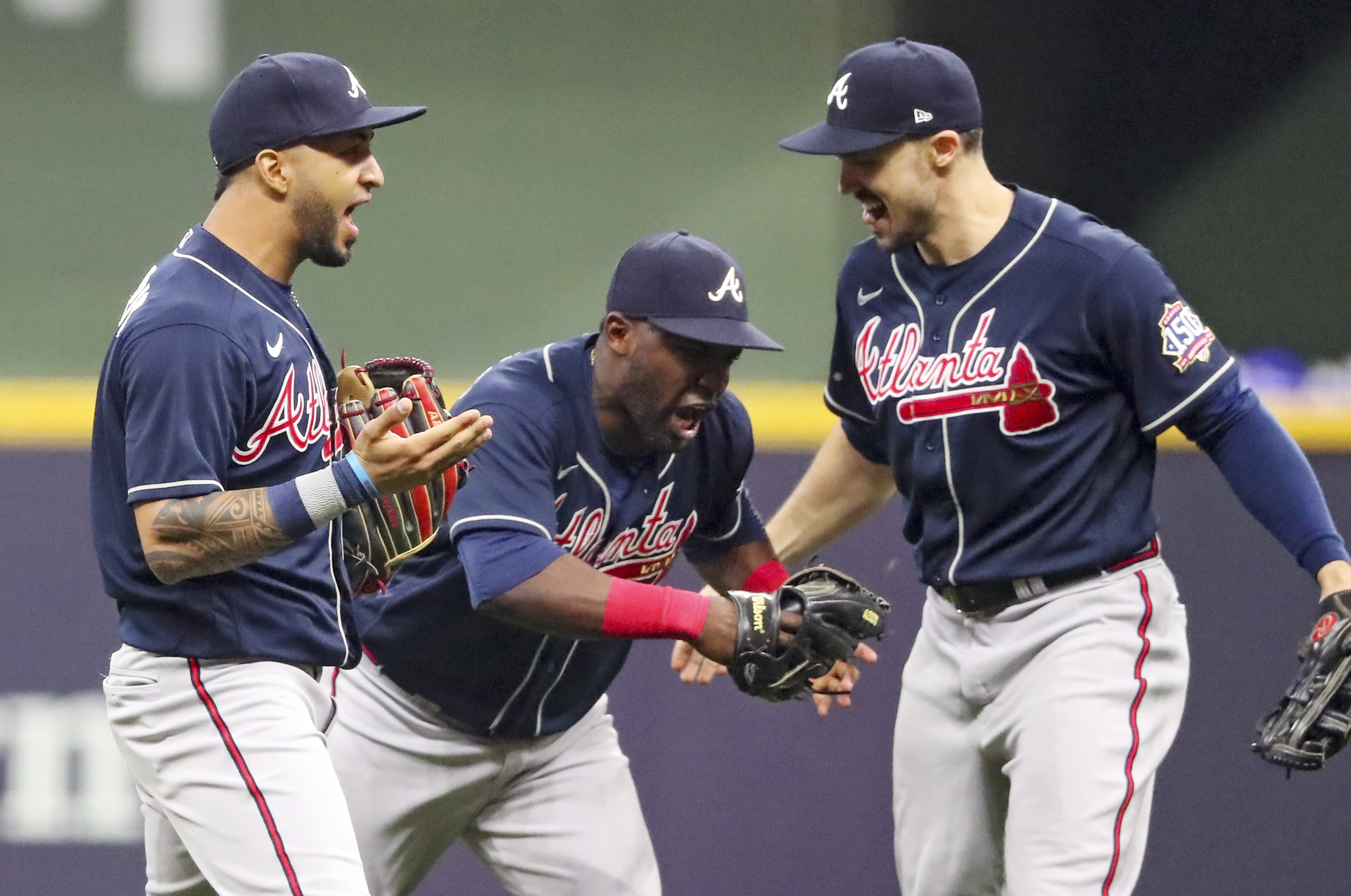Braves left fielder Eddie Rosario (8), right fielder Jorge Soler (12) and center fielder Adam Duvall (14) celebrate the 3-0 victory. Curtis Compton / Curtis.Compton@ajc.com